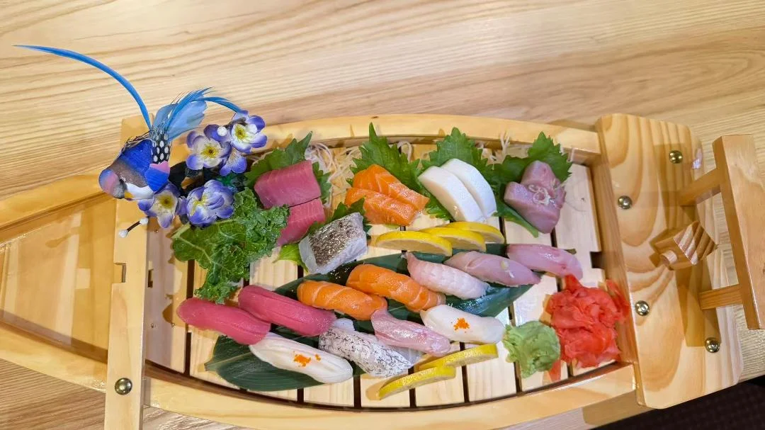 Assorted Japanese sushi platter on a wooden boat