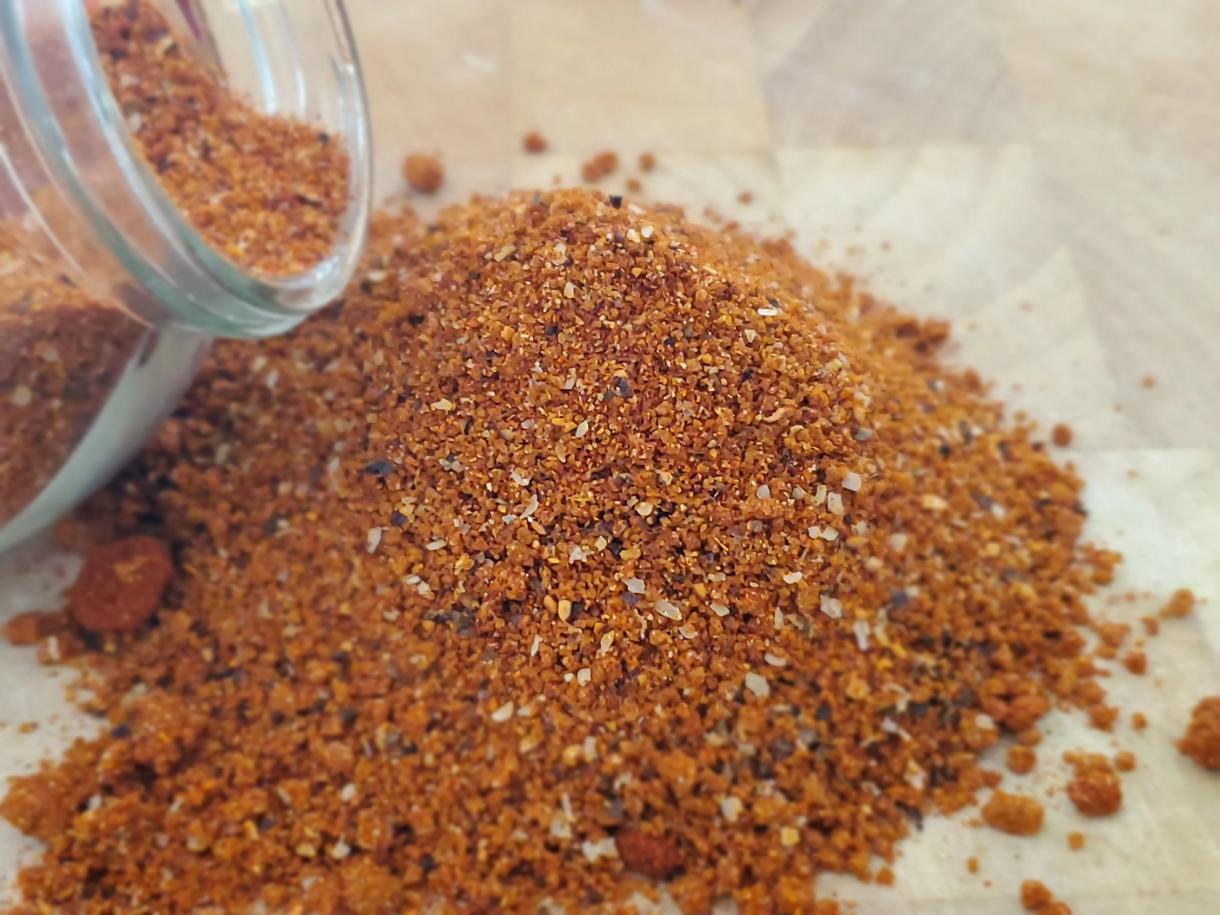 Spicy Mexican chili powder blend on a wooden surface