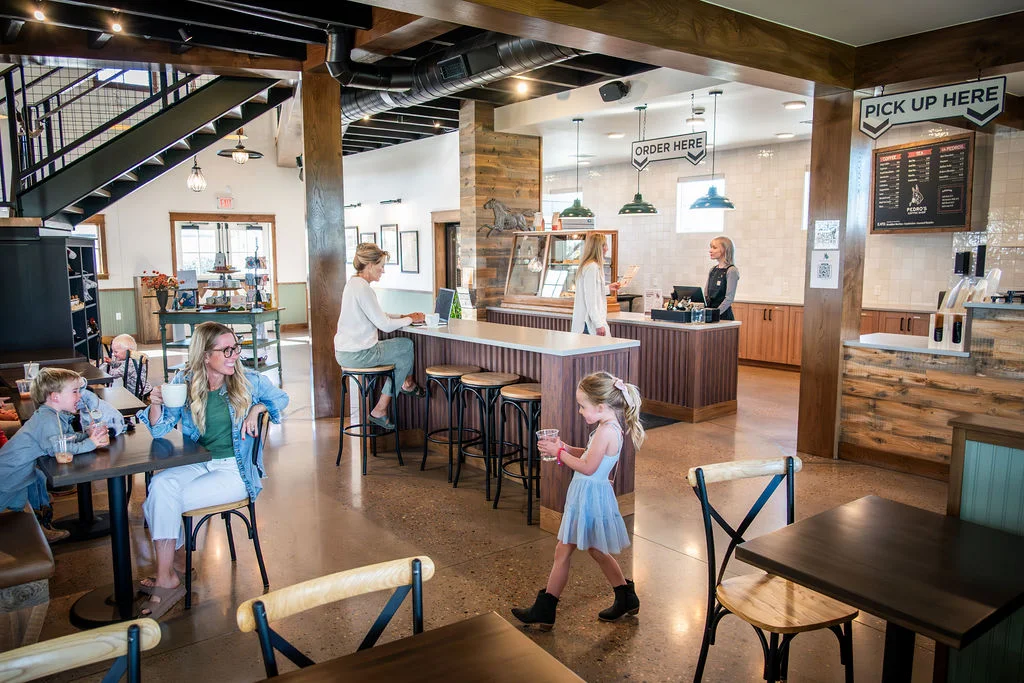 Modern café interior with families enjoying coffee and pastries