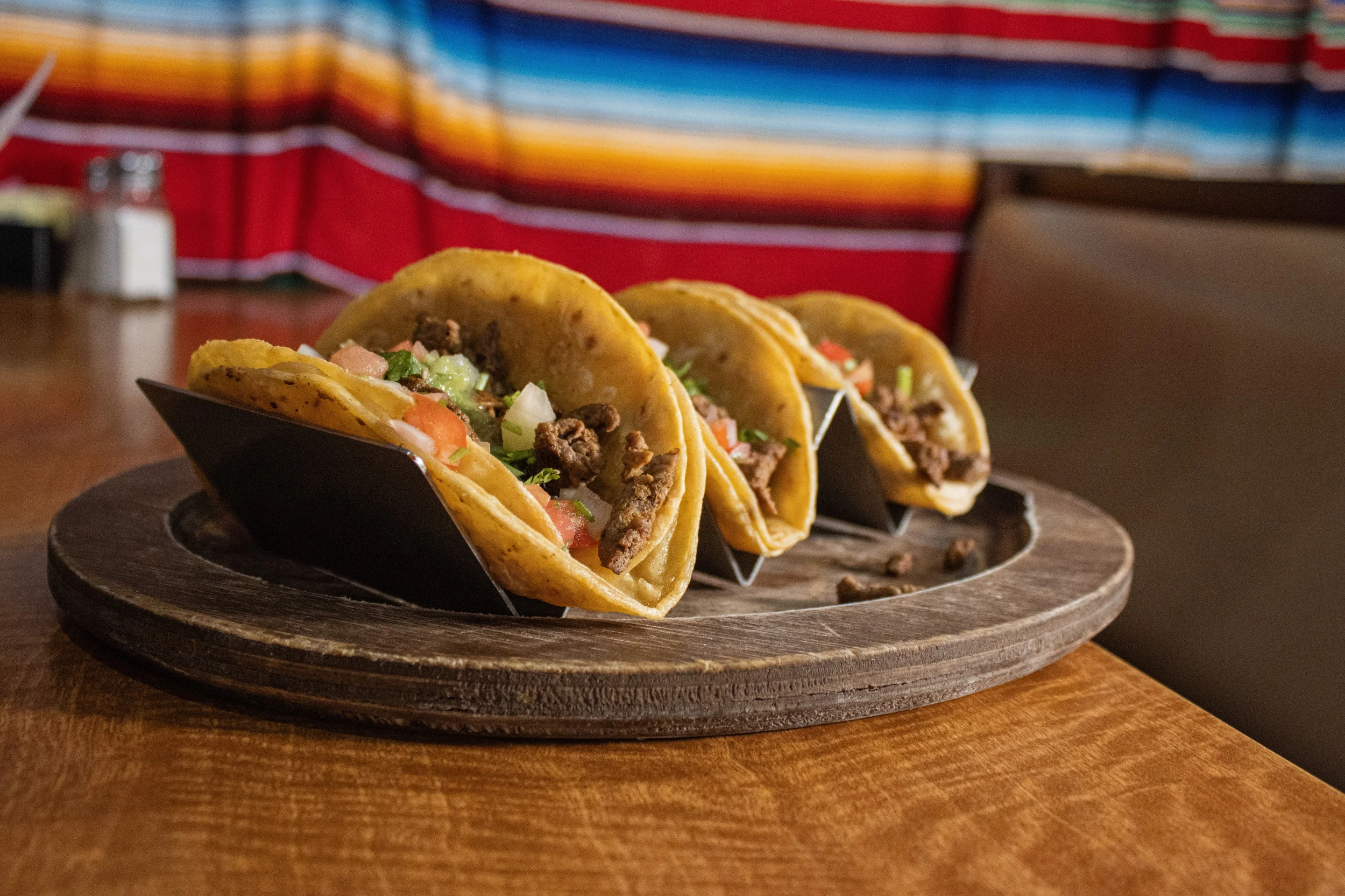 Delicious Mexican street tacos served on a wooden platter