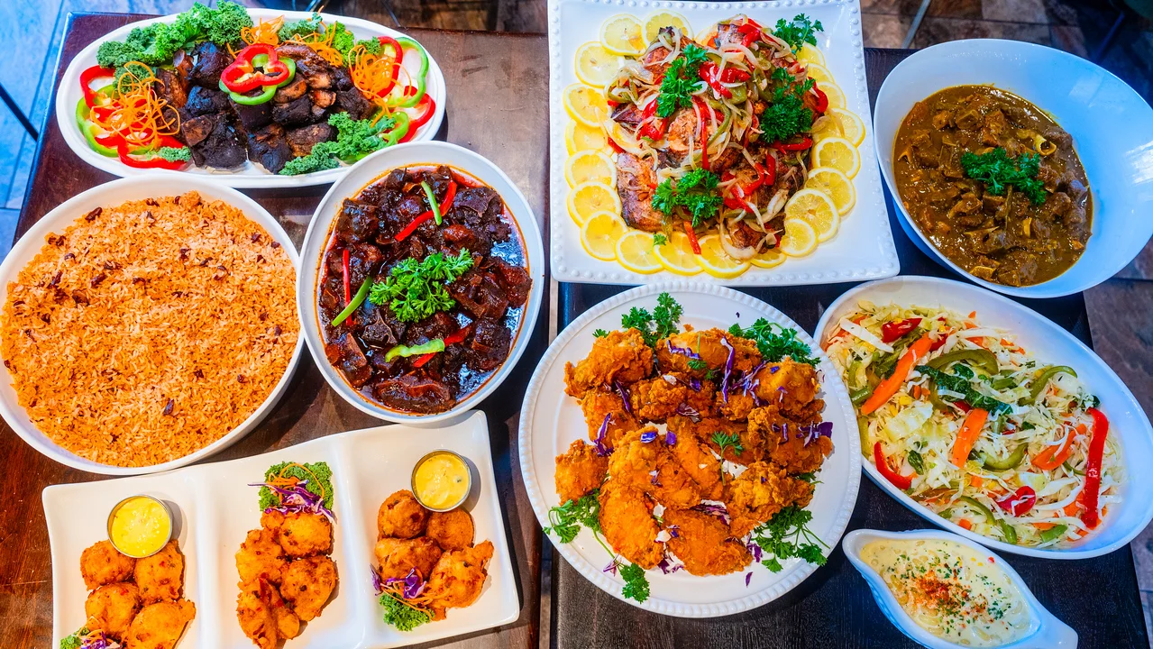 Assorted Caribbean dishes including fried chicken and rice