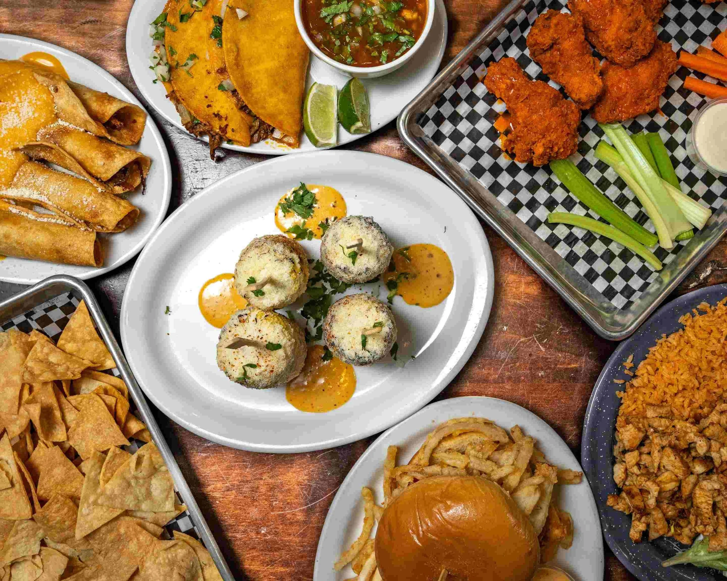 Assorted Mexican dishes including tacos and flautas
