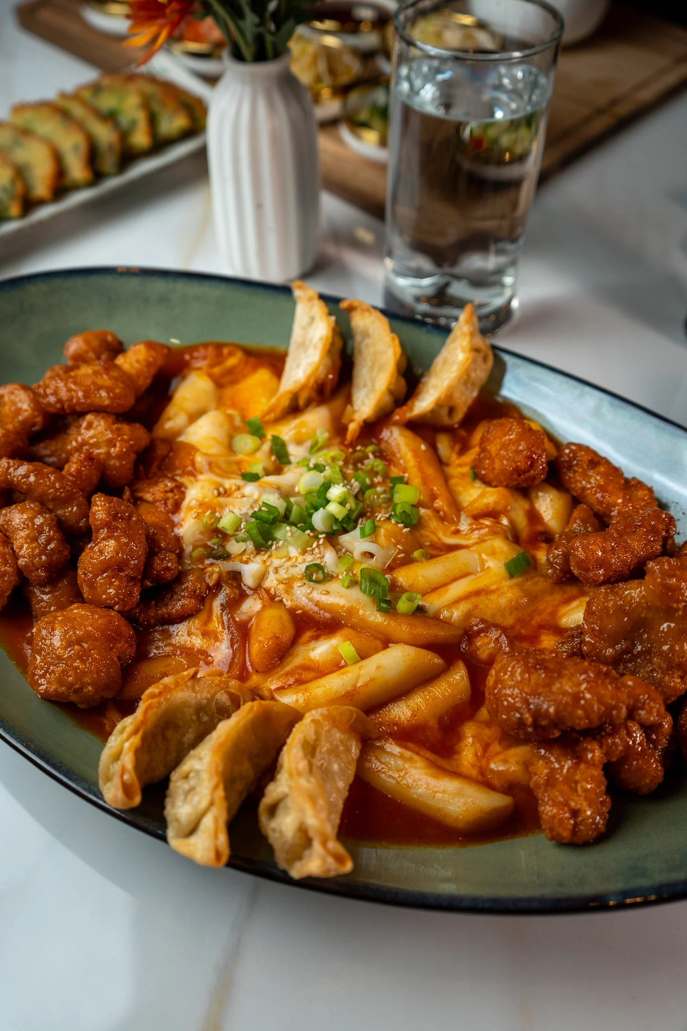 Korean tteokbokki with fried chicken and dumplings