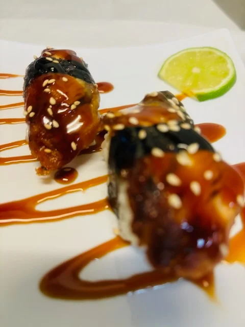 Japanese unagi sushi rolls drizzled with sweet sauce