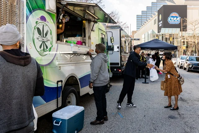 Food truck serving diverse street food at a vibrant outdoor event