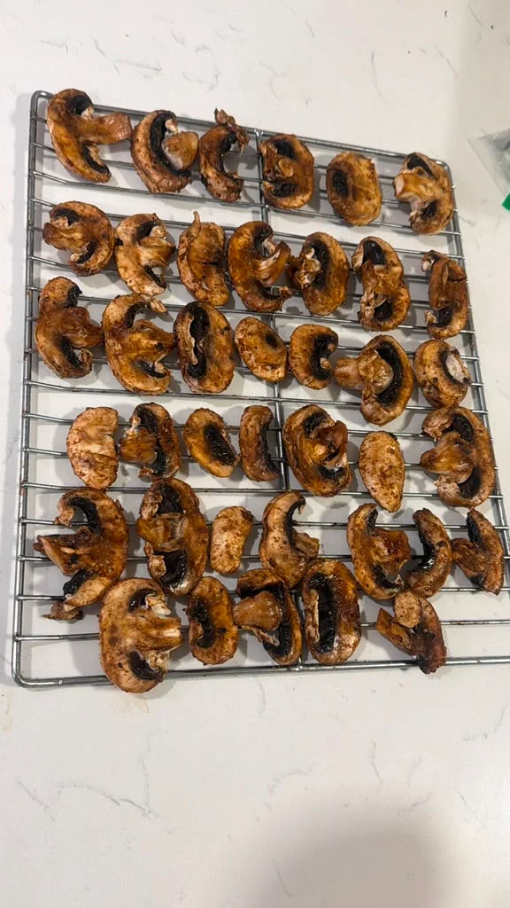 Oven-roasted mushrooms on a cooling rack, showcasing a savory snack preparation