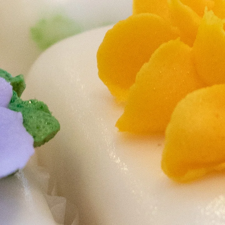 Colorful floral petit fours on a wooden table