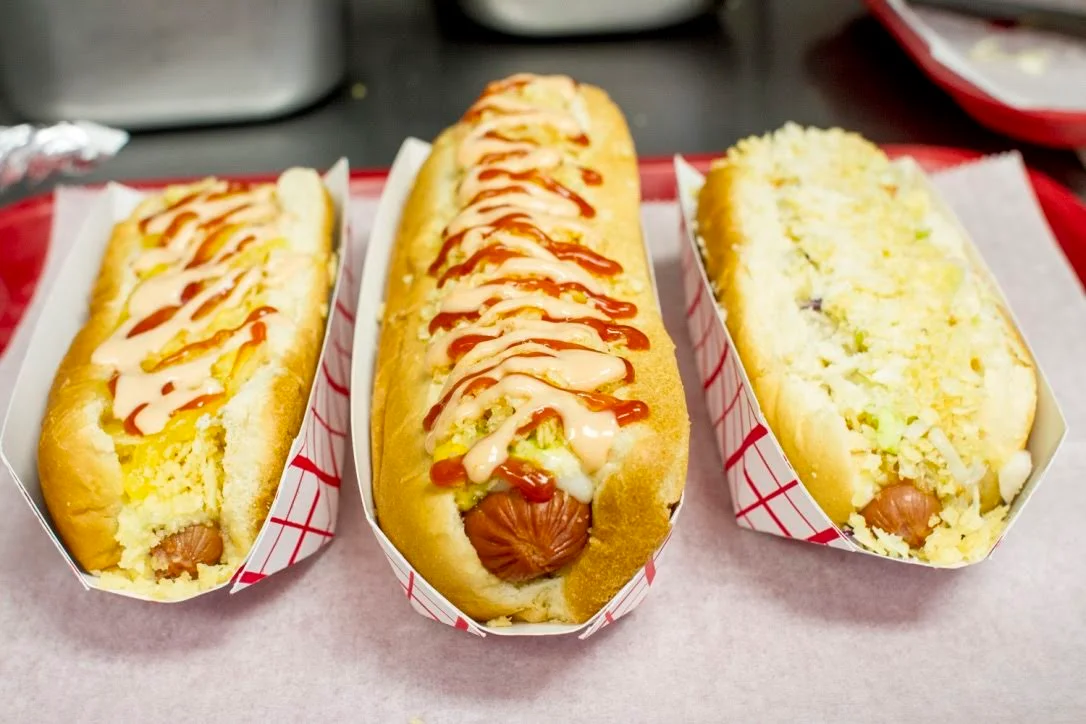 Gourmet hot dogs with various toppings
