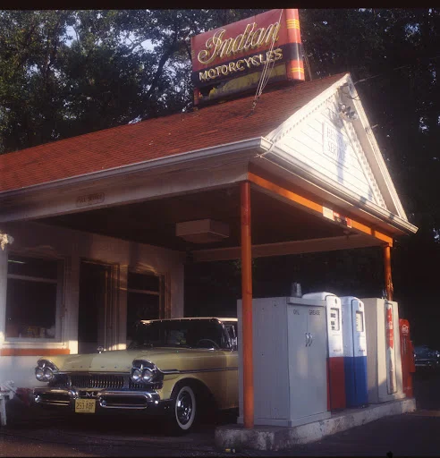 Vintage gas station with classic car and Indian Motorcycles sign