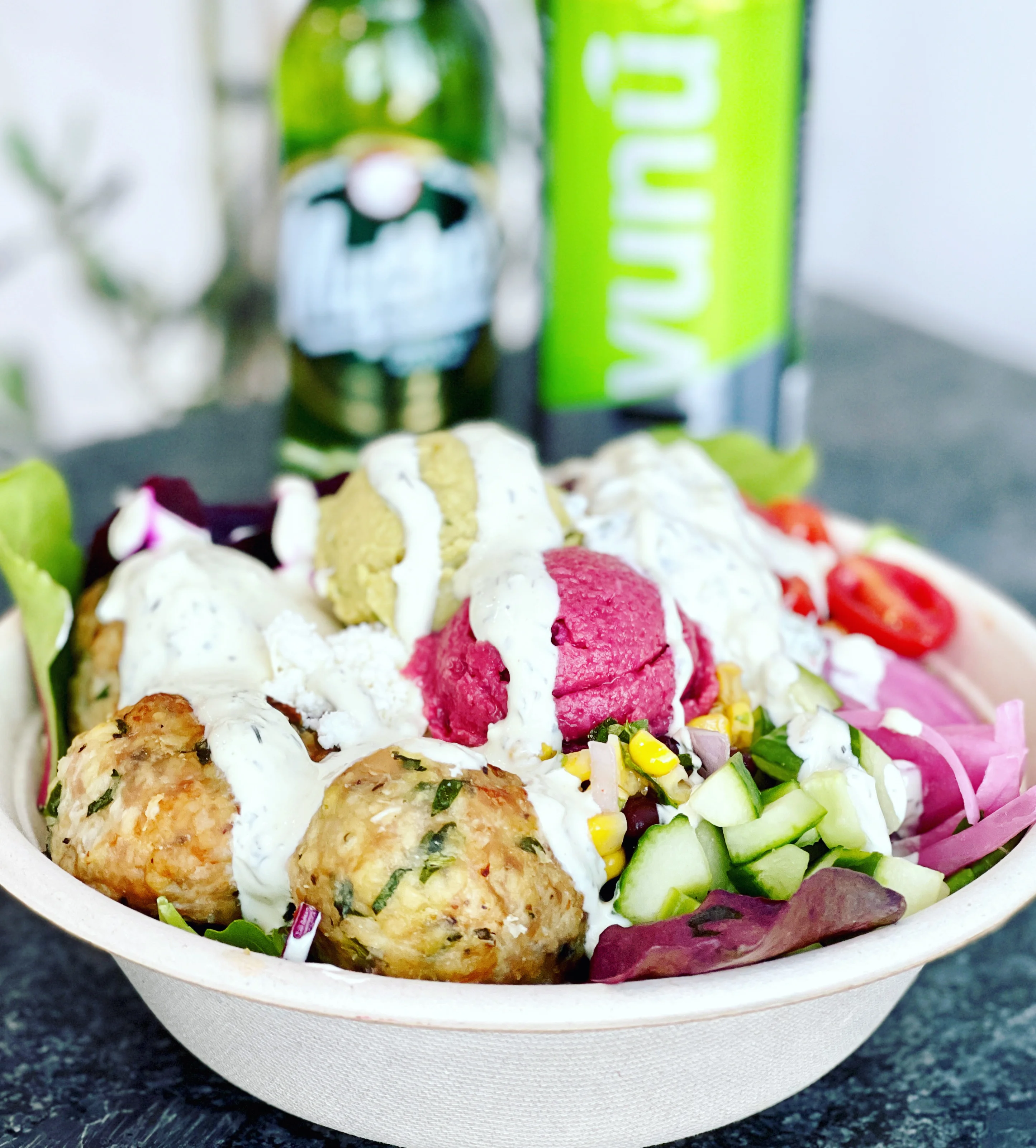 Mediterranean mezze bowl with falafel and yogurt sauce