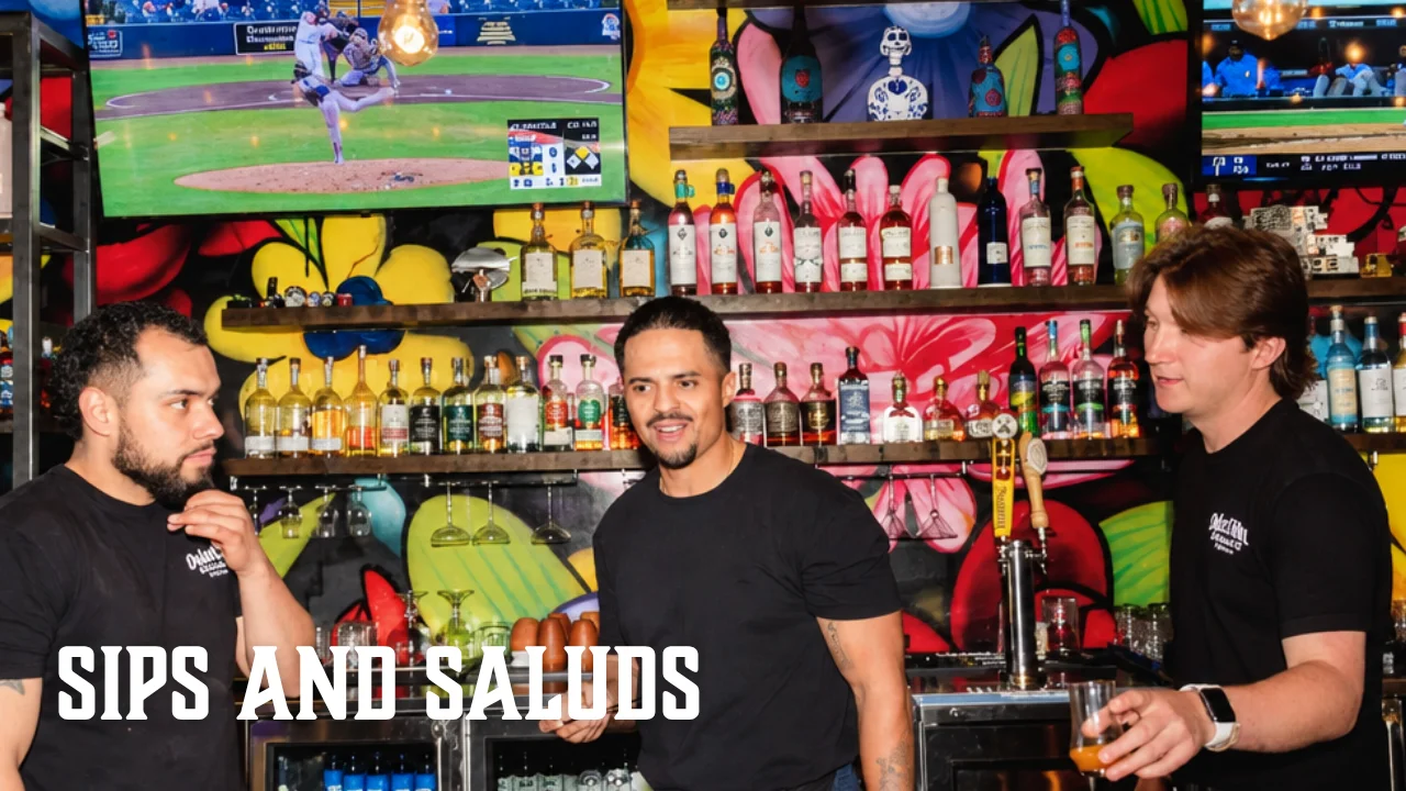 Bartenders engaging at a vibrant bar with colorful decor and drinks