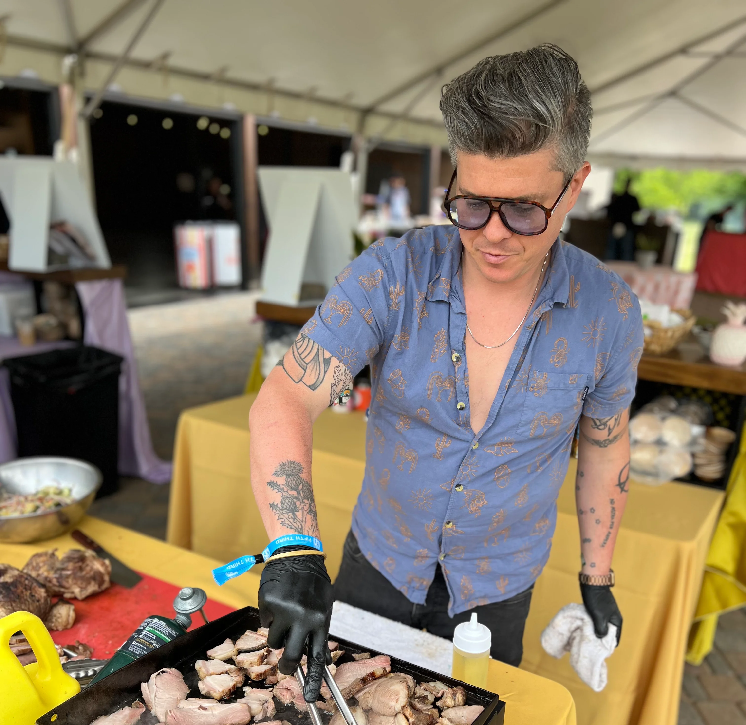 Grilling pork belly at a vibrant food festival