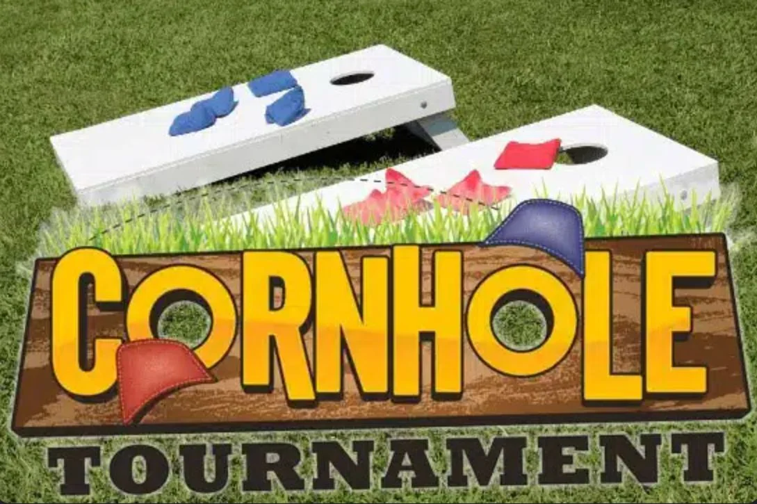 Cornhole tournament setup on a grassy field