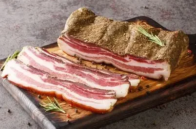 Cured Italian guanciale on a wooden board
