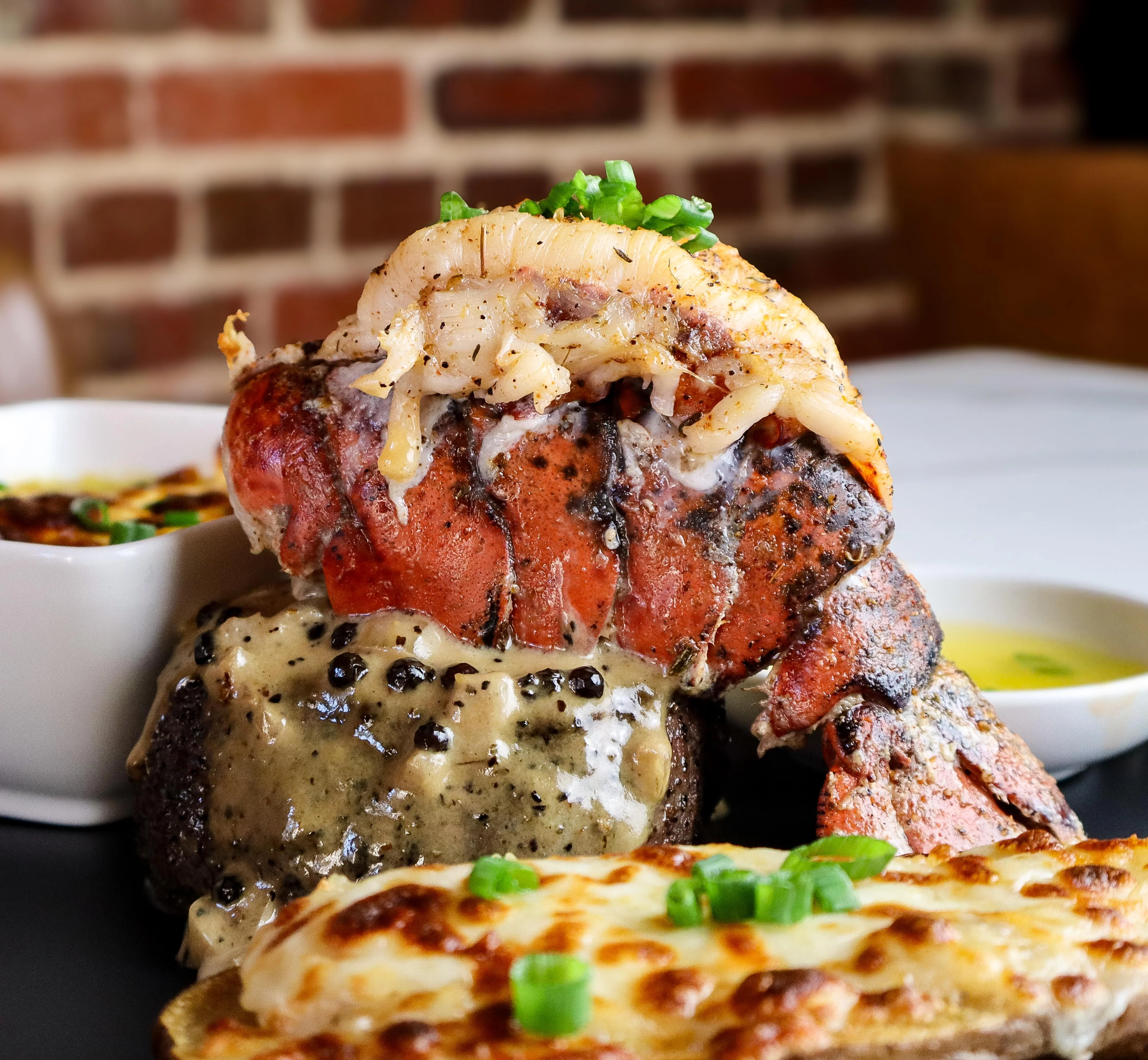 Grilled lobster tail with steak and cheese sauce