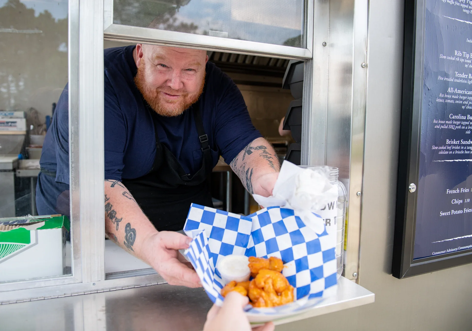 Food truck serving buffalo wings with dipping sauce
