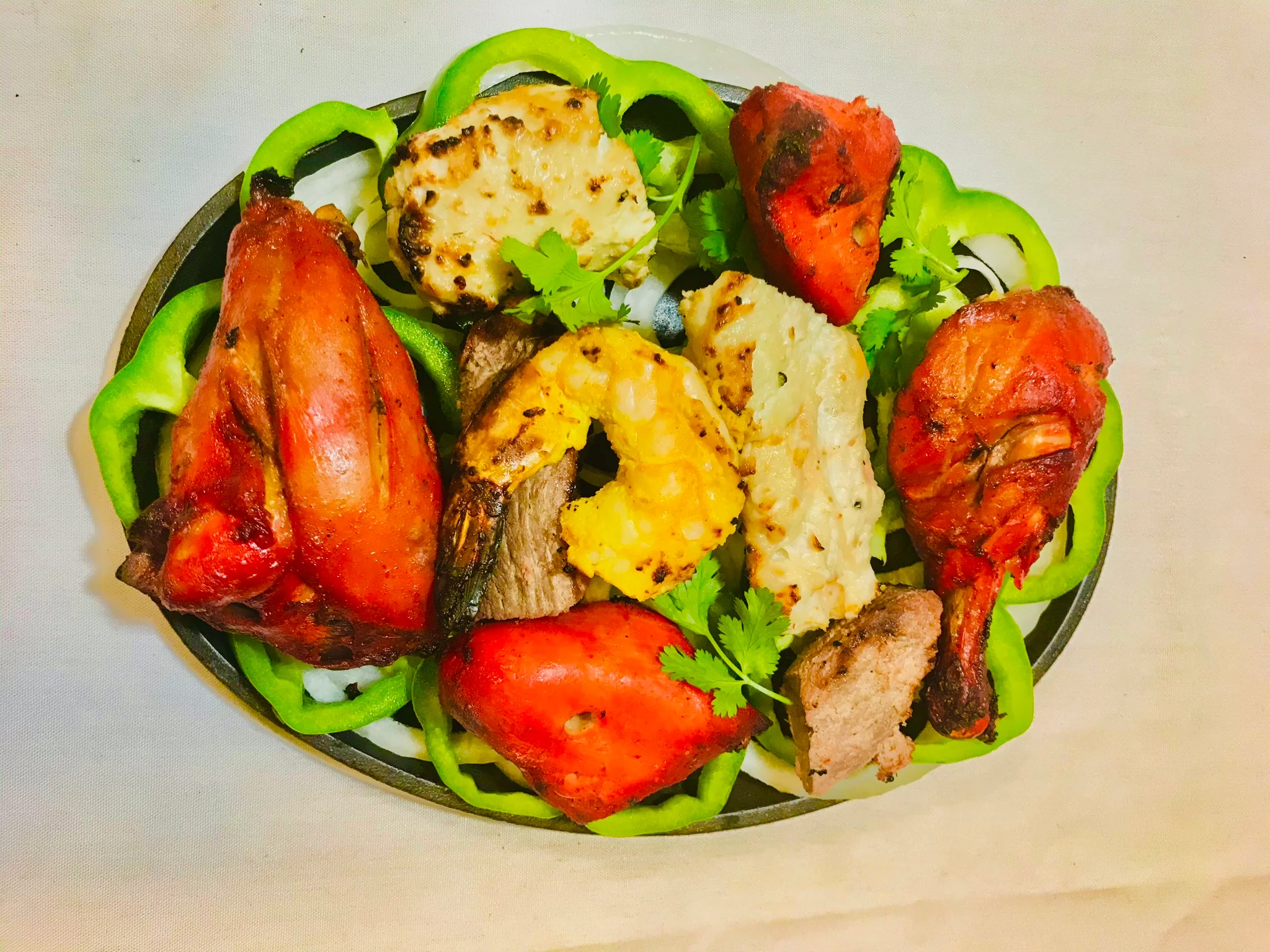 Mixed grill platter featuring tandoori chicken and shrimp