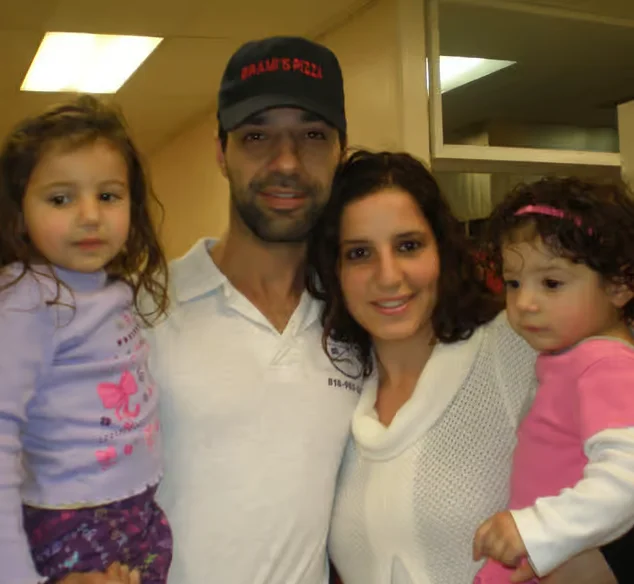 Family portrait in a restaurant setting with children and adults