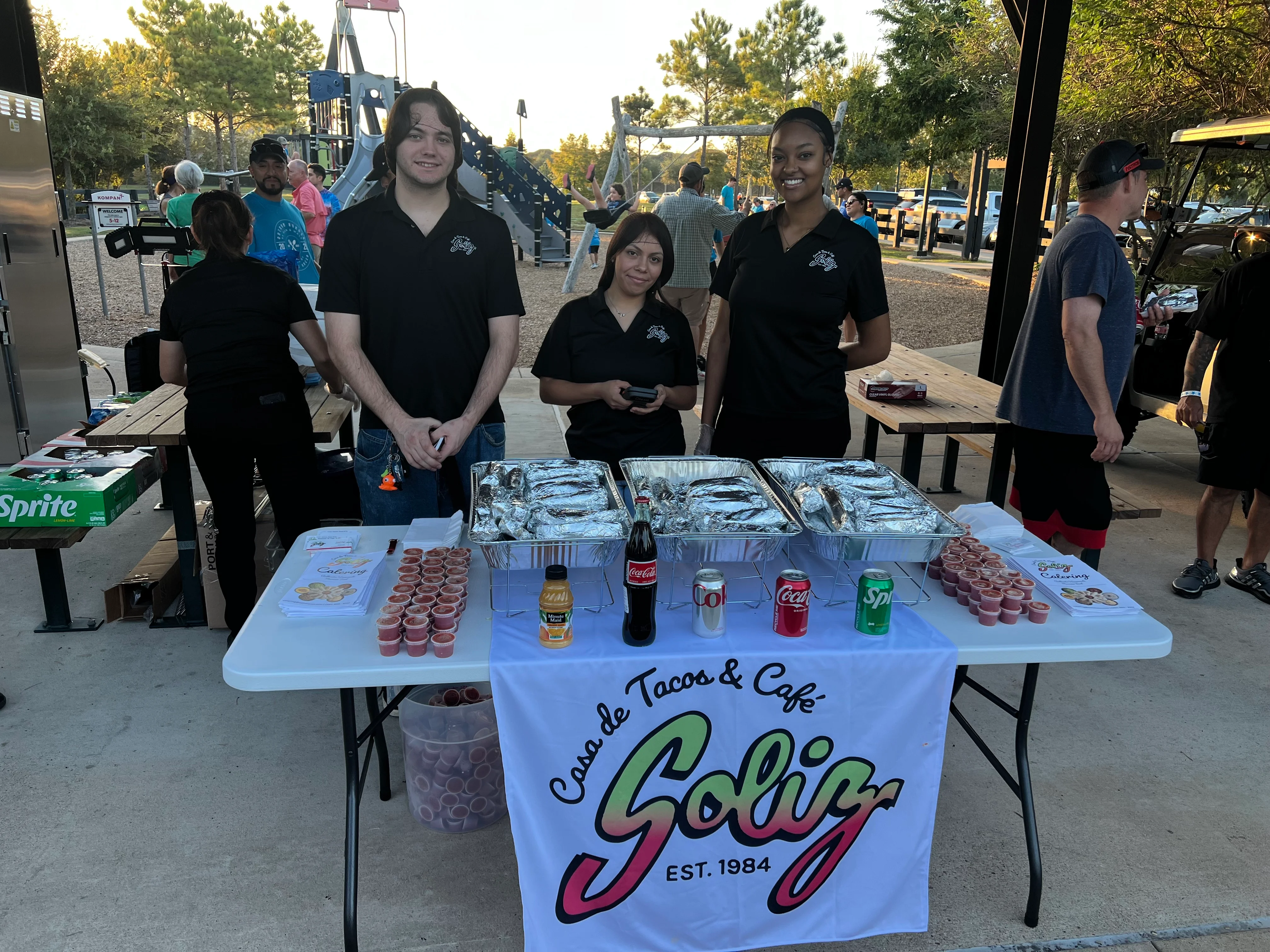 Staff serving Mexican cuisine at a community event