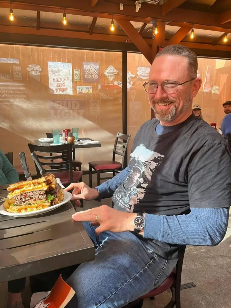 Giant American cheeseburger with layers of meat and toppings