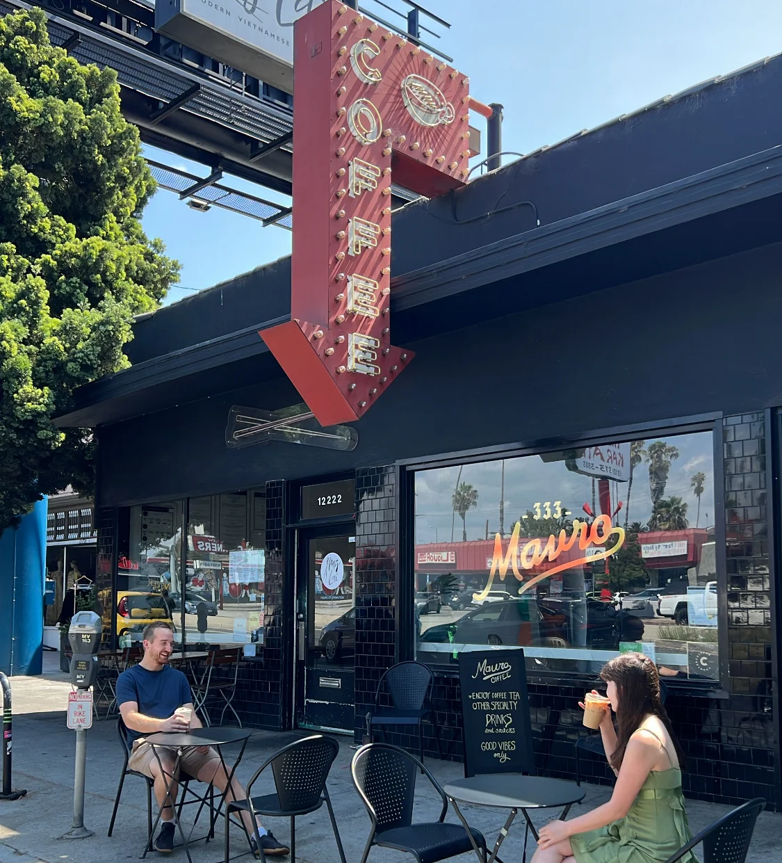 Outdoor coffee shop with patrons enjoying drinks