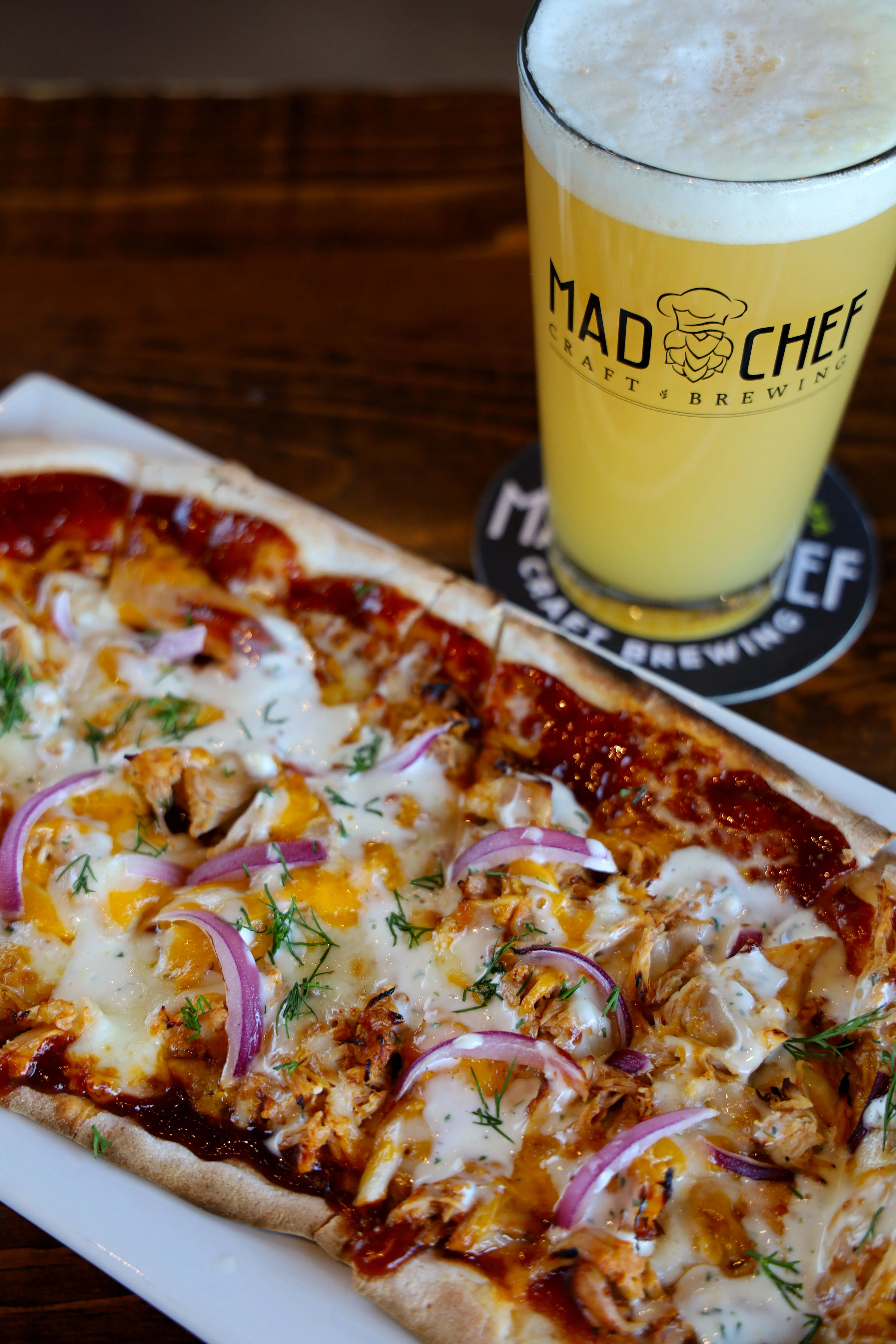 Delicious chicken broccoli Alfredo flatbread topped with cheese and herbs.