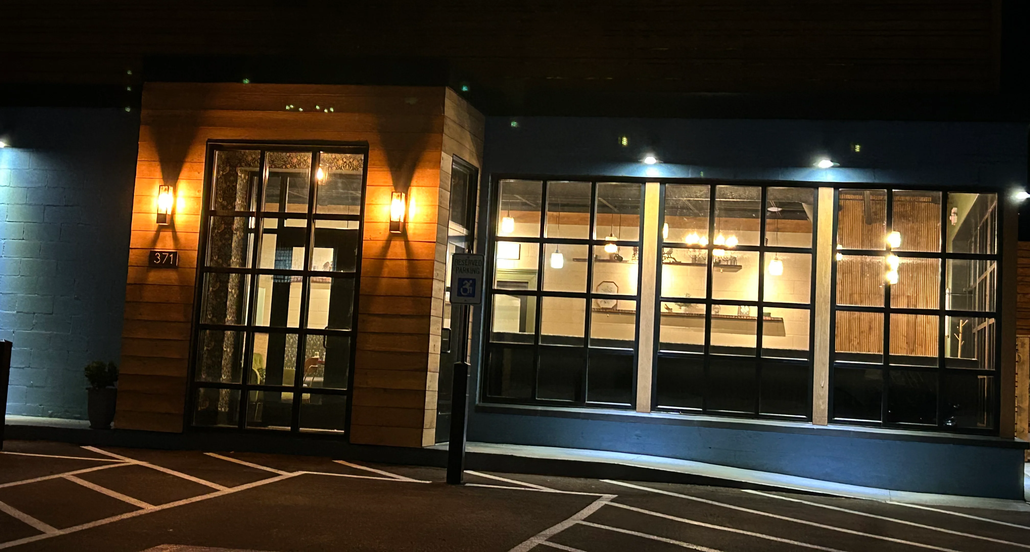 Modern restaurant exterior with warm lighting at night