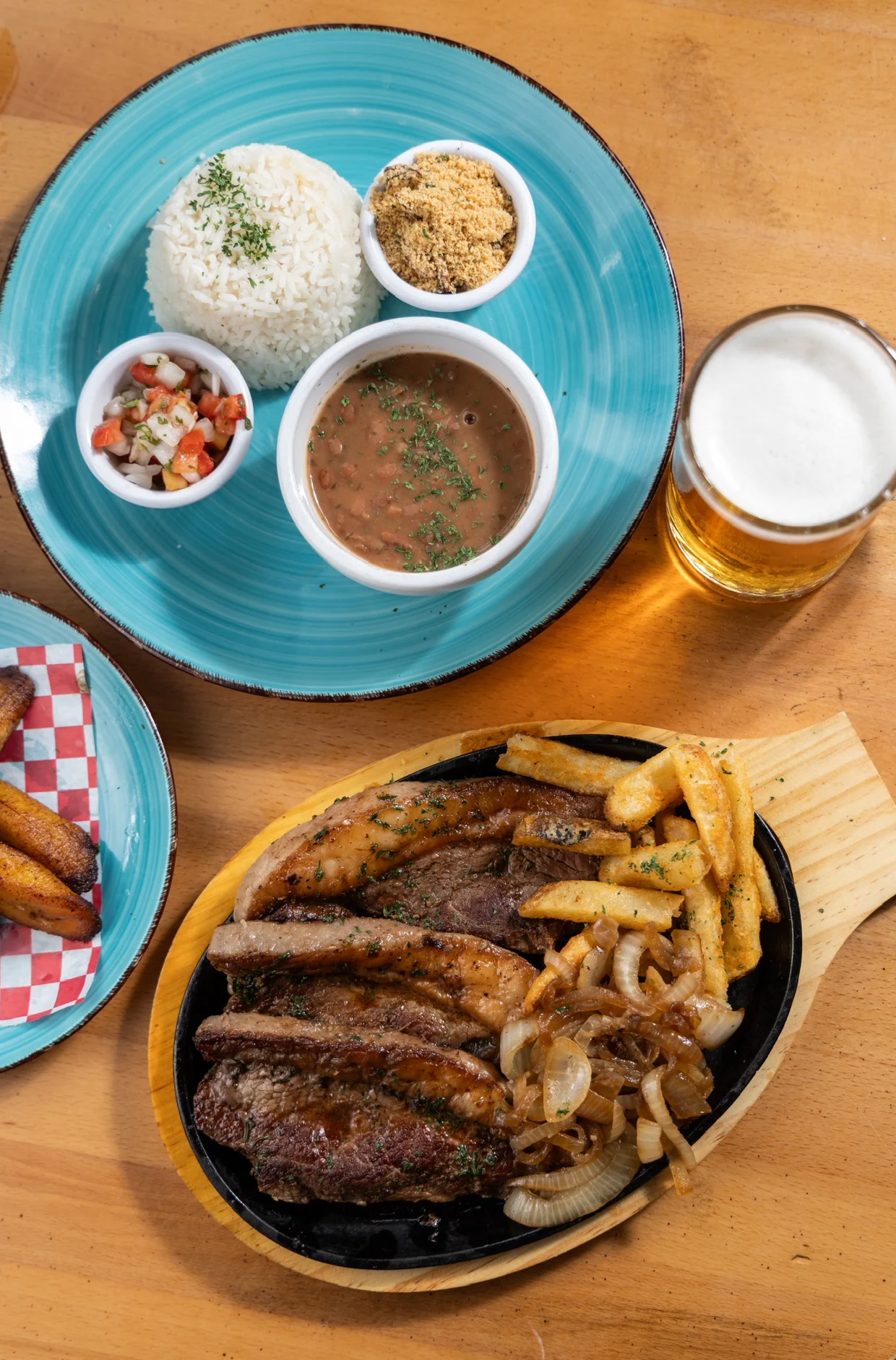 Sizzling Brazilian picanha steak with rice and beans