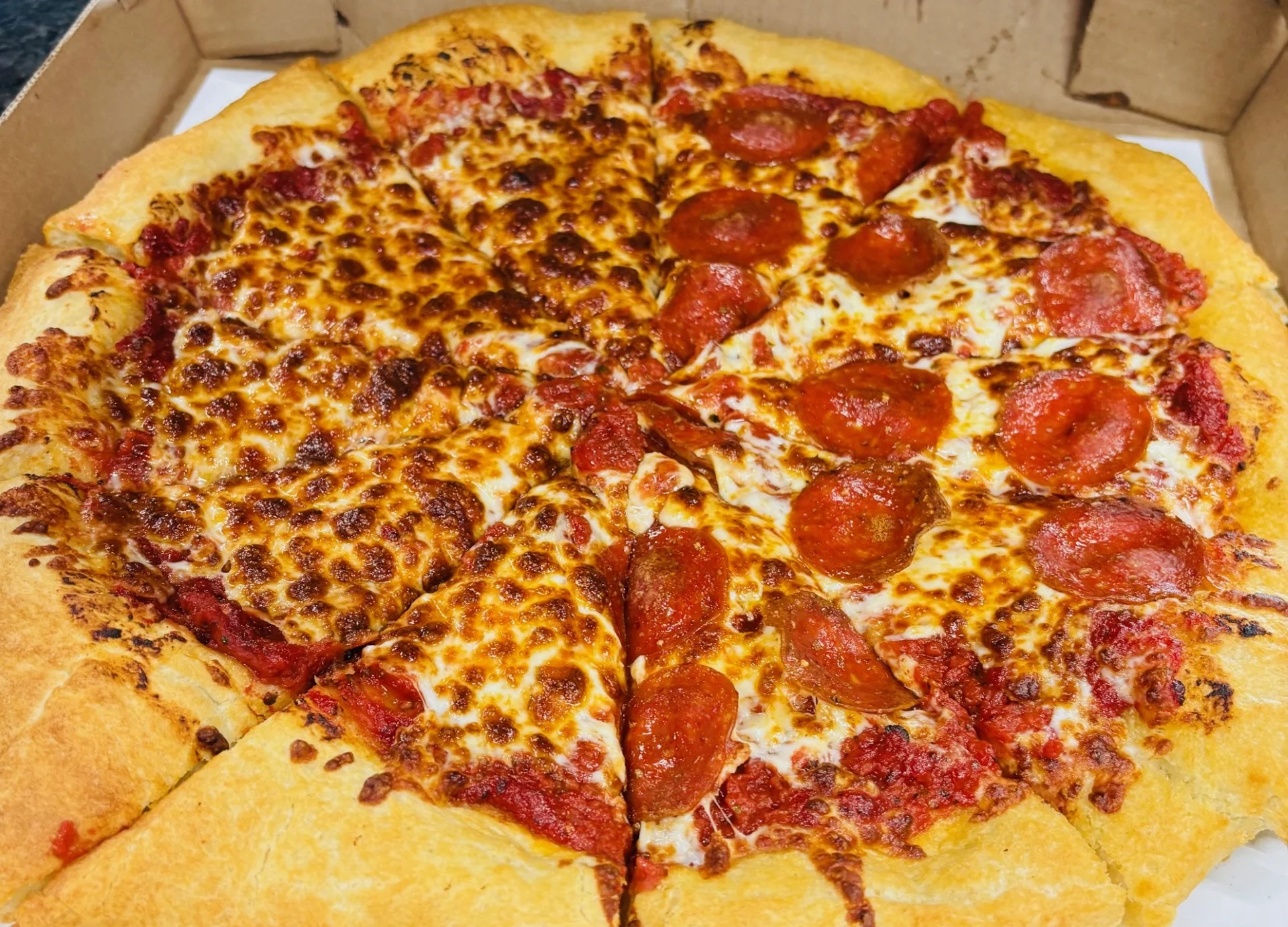 Pepperoni pizza in a cardboard box