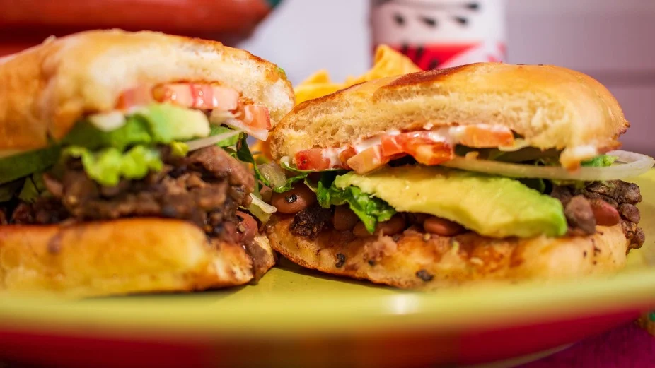 Delicious gourmet burger with fresh toppings on a wooden table