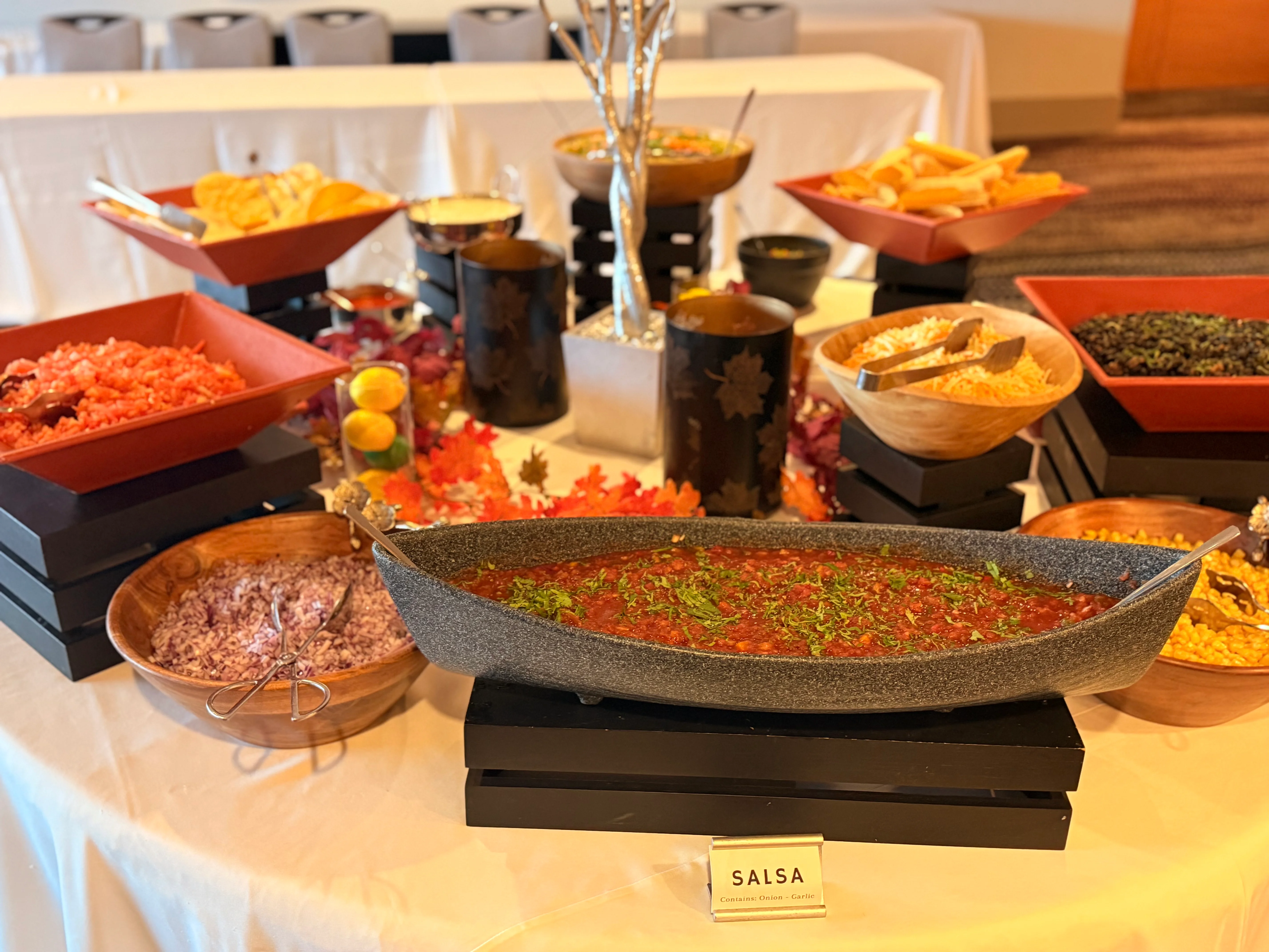 Colorful salsa bar with various toppings and dips
