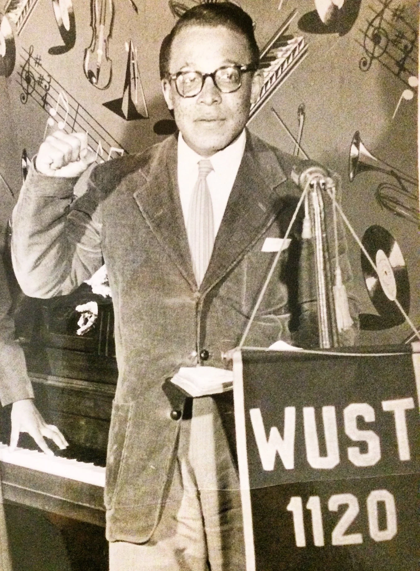 Historical photo of a radio broadcast with musicians and speakers.