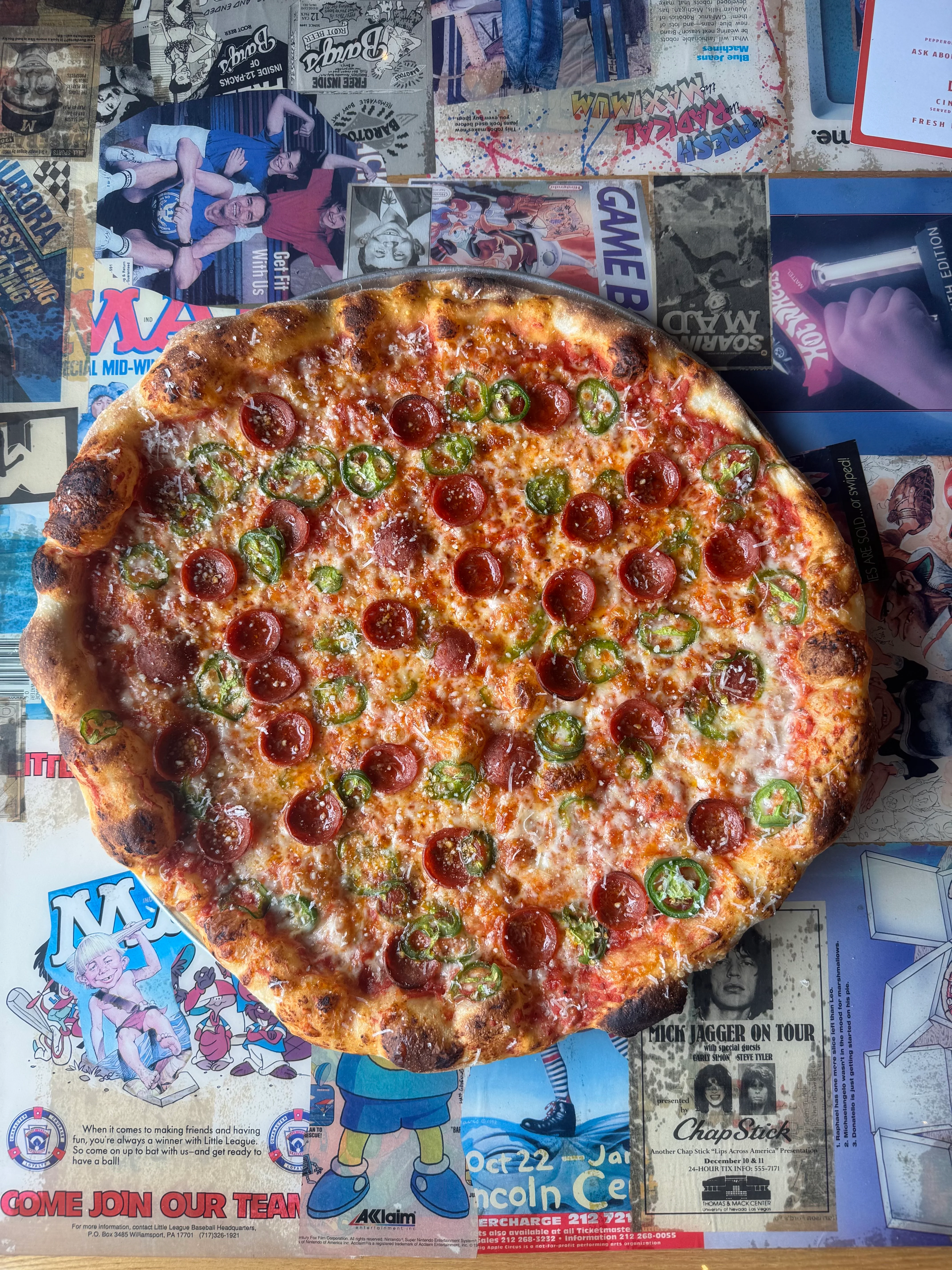 Pepperoni pizza with jalapeños on a vibrant table
