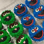 Colorful cupcakes decorated as cartoon characters