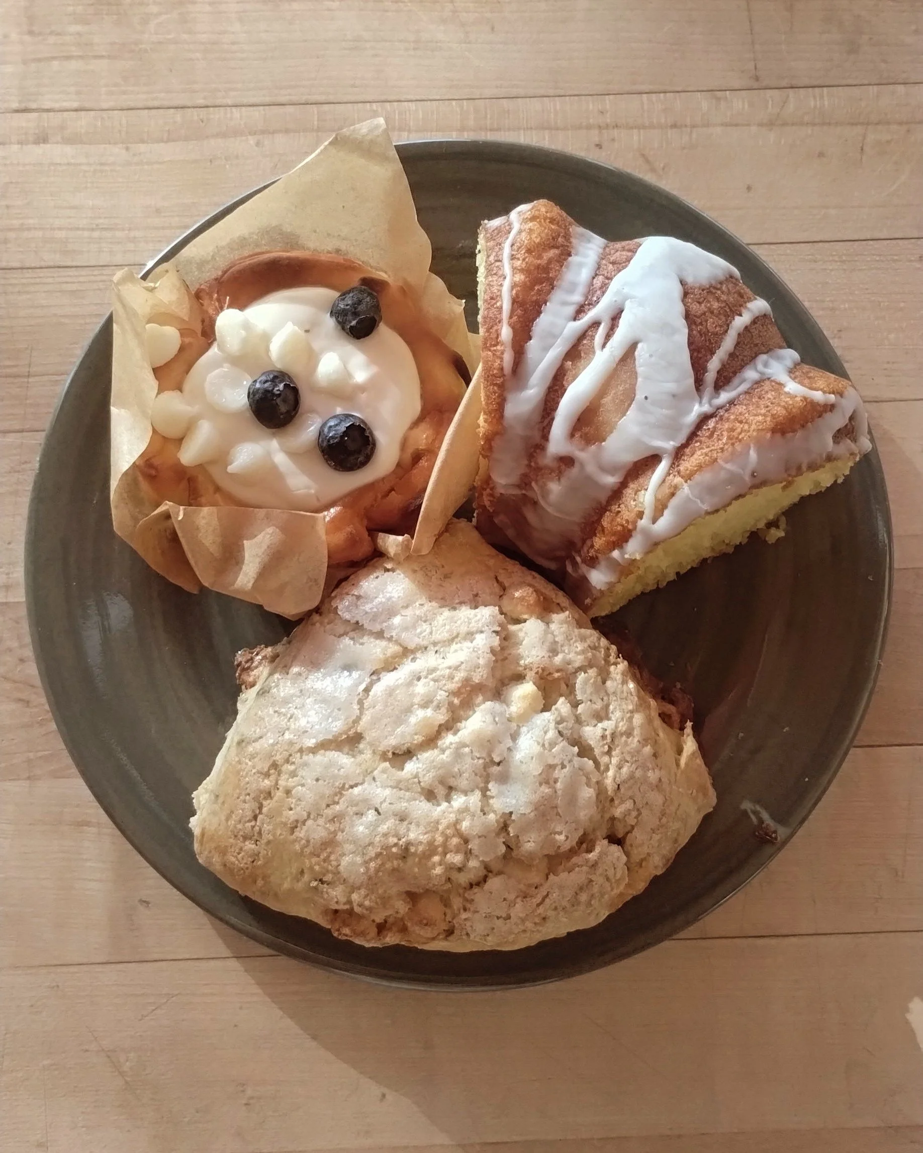Assorted pastries including a muffin and a coffee cake on a plate