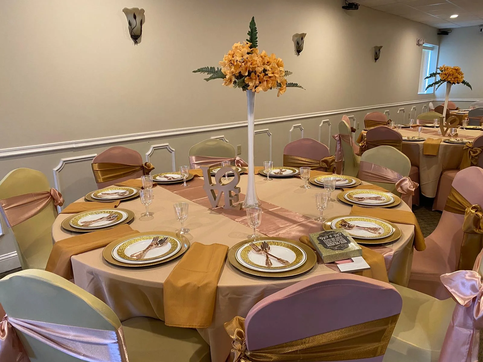 Elegant dining setup with floral centerpieces and gold accents