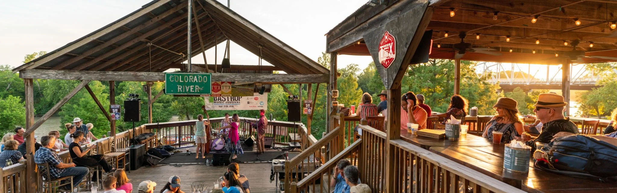 Outdoor music venue by the Colorado River at sunset