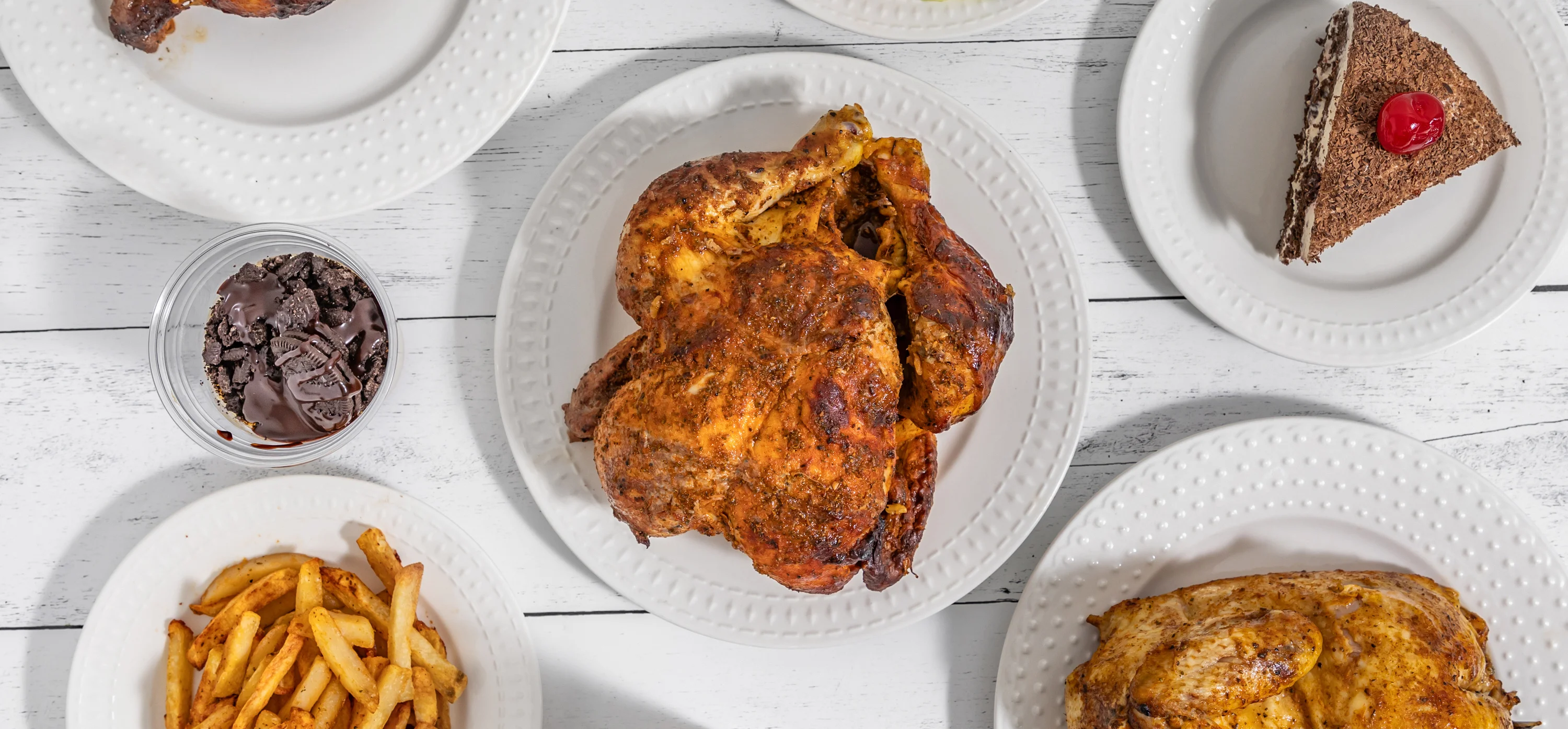 Delicious roasted chicken platter with sides and dessert