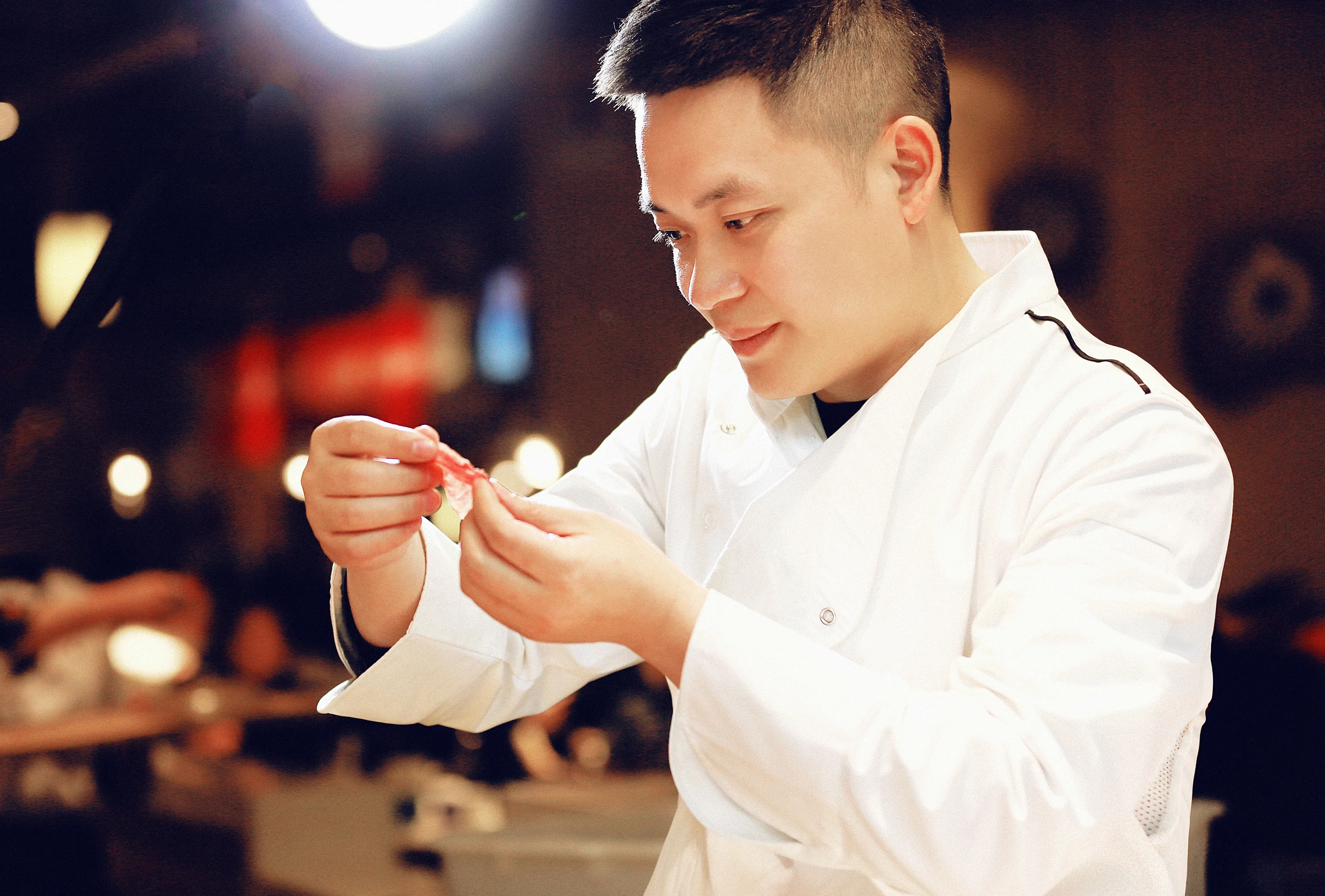 Chef preparing sushi with precision in a modern restaurant