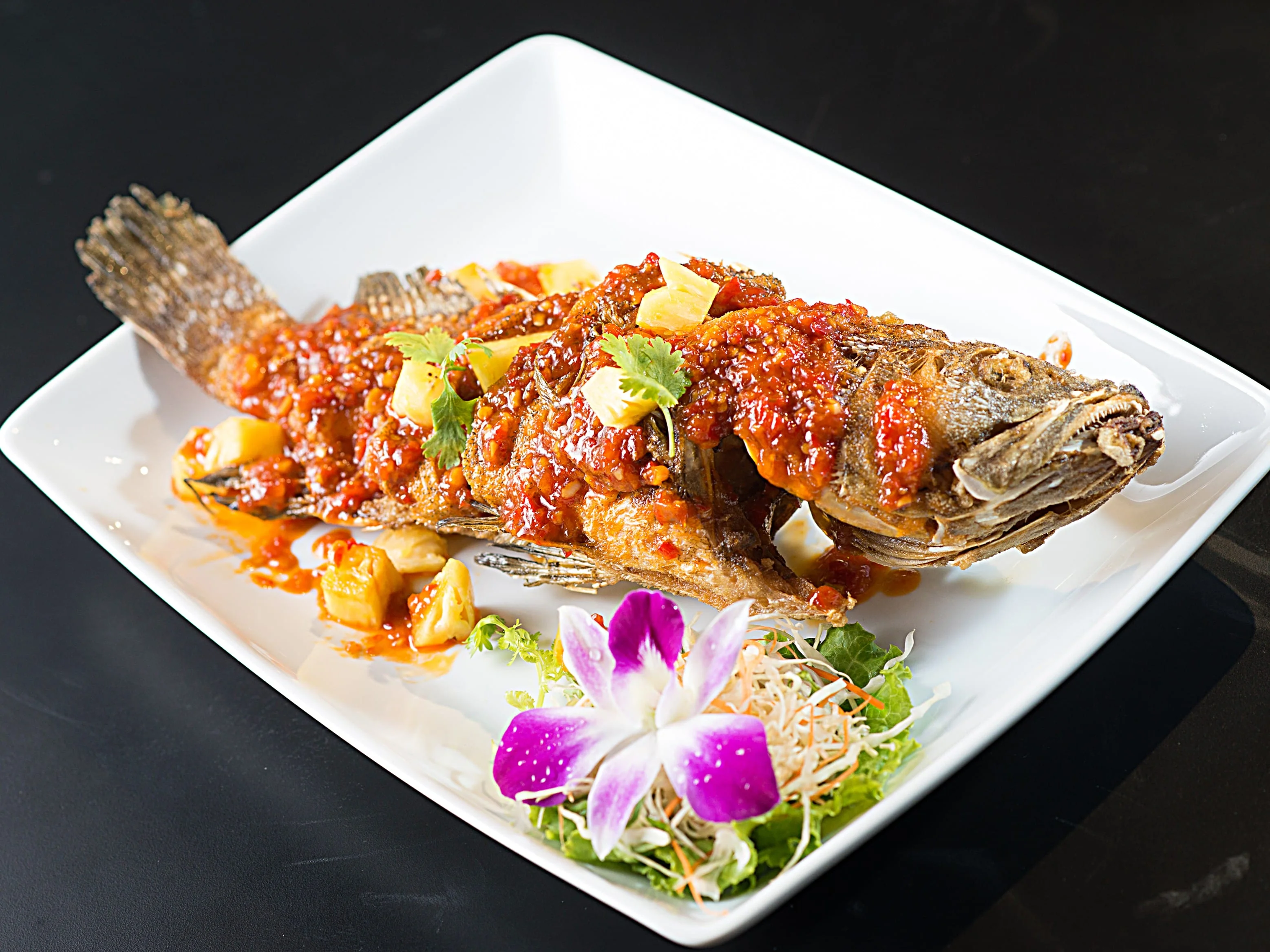 A beautifully arranged plate of gourmet food with vibrant colors.