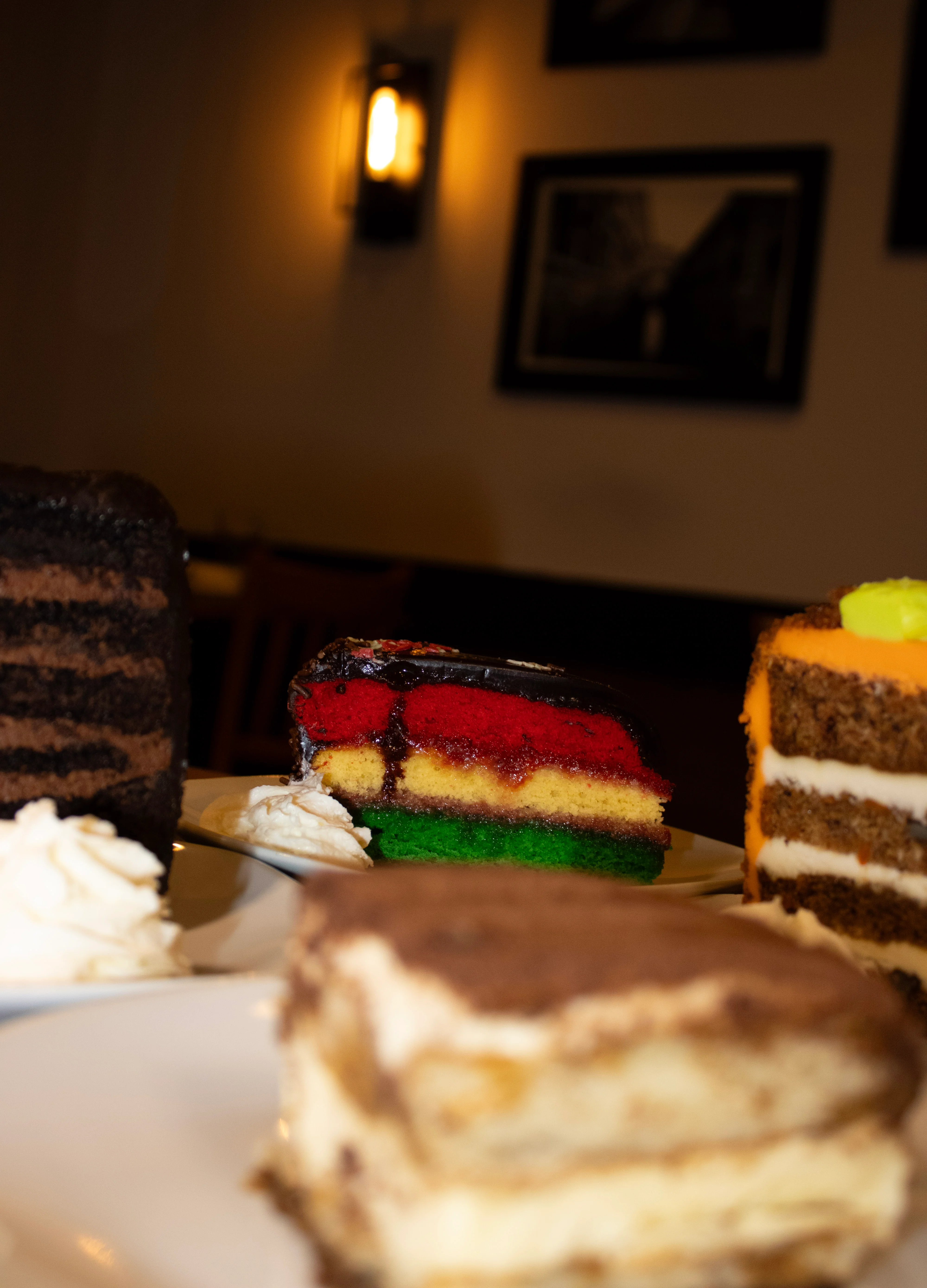 Colorful Italian rainbow cake with layers and whipped cream