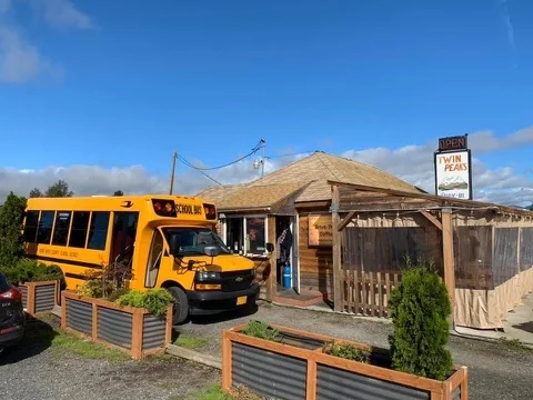 Charming restaurant exterior with a school bus parked outside