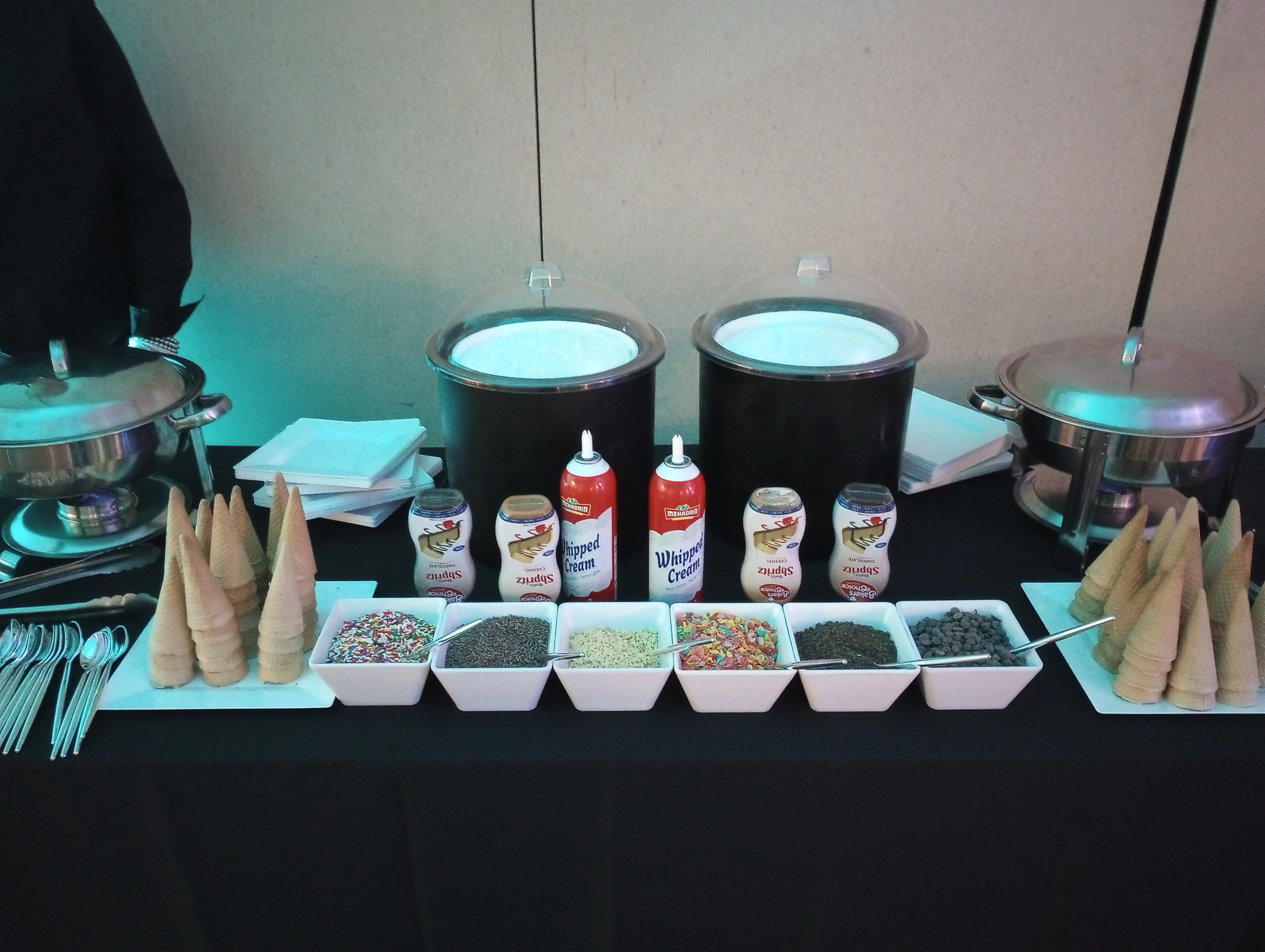 Ice cream sundae bar with cones and toppings