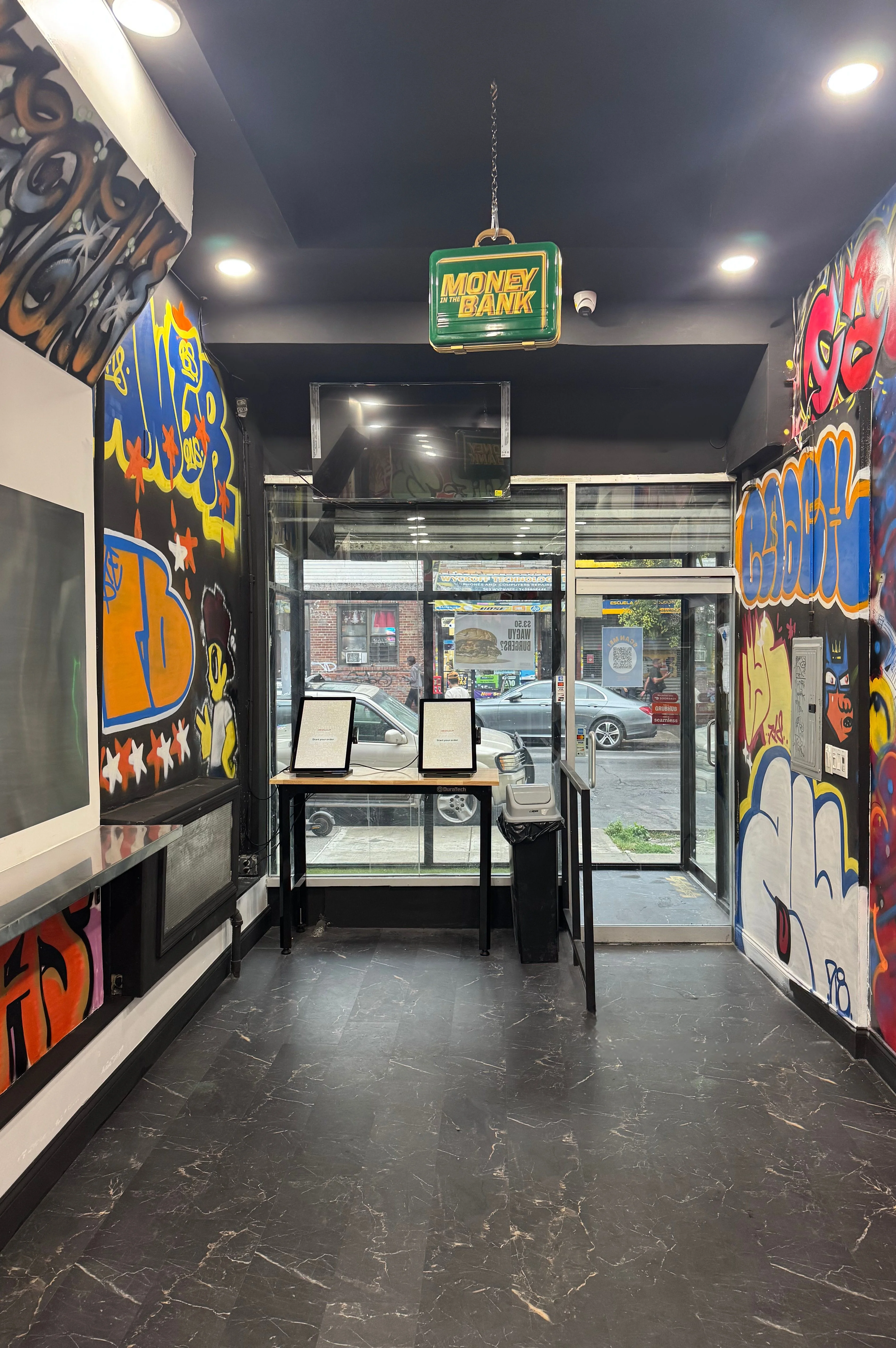 Vibrant restaurant entrance with graffiti art and modern decor