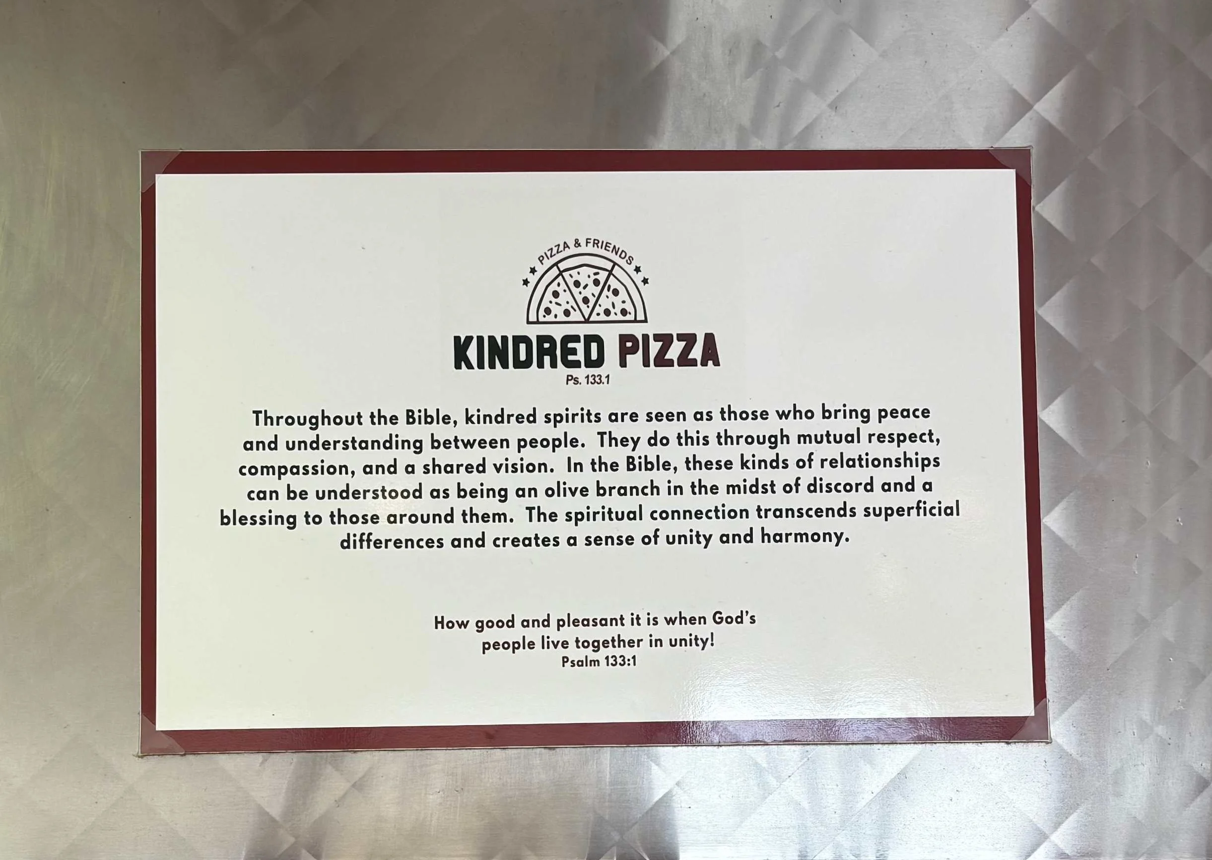 Kindred Pizza restaurant message about unity and community