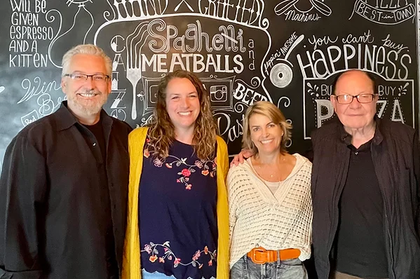 Group of friends at a restaurant with a chalkboard menu