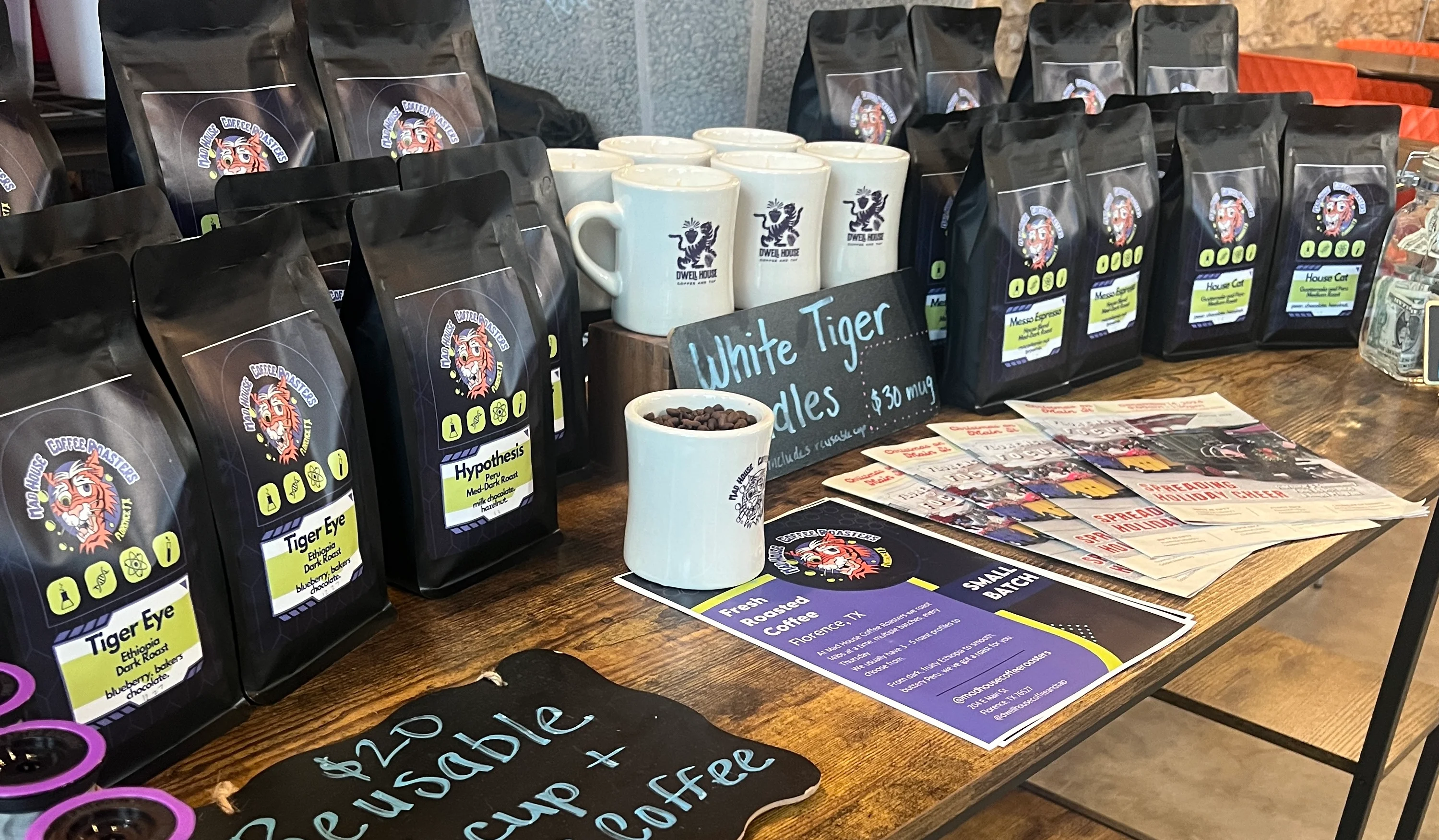Coffee display with various blends and mugs at a cozy café