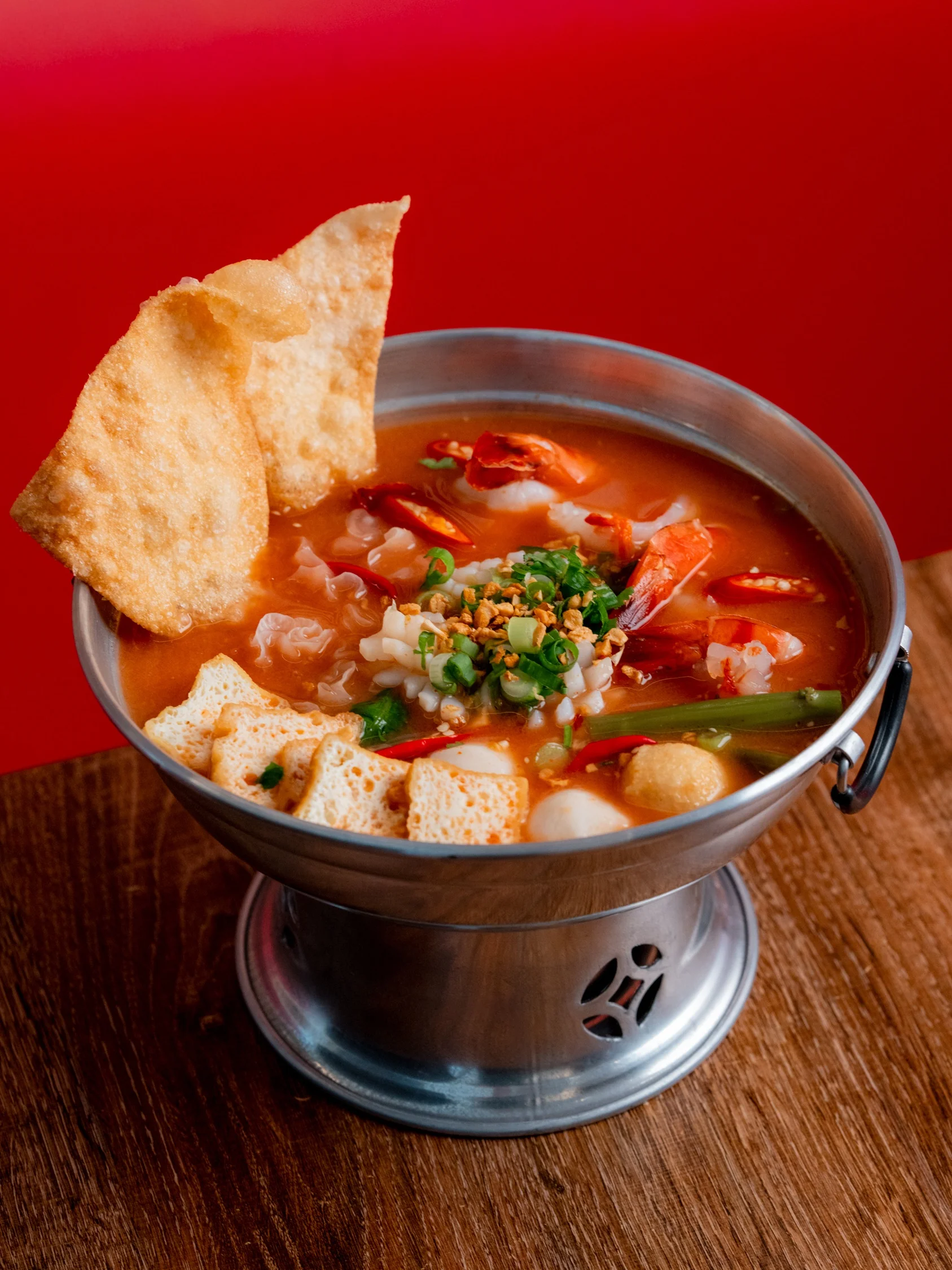 Spicy Thai tom yum soup with shrimp and crispy wontons