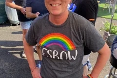 Person wearing a rainbow shirt at a community event