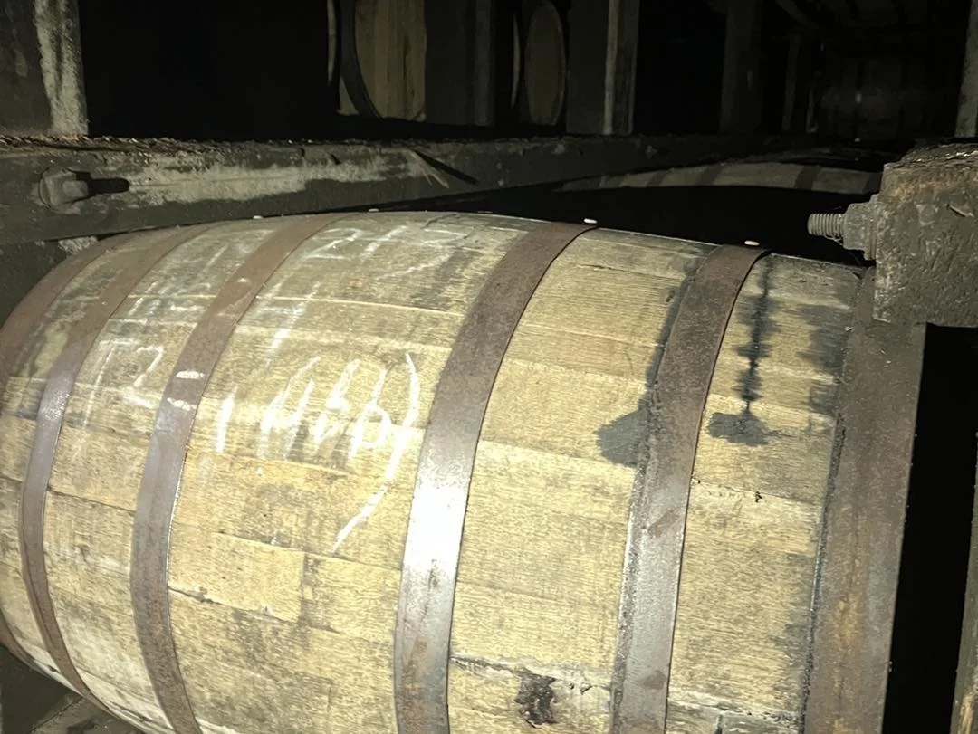 Aged wooden barrel in a dimly lit cellar
